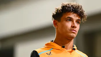 SINGAPORE, SINGAPORE - SEPTEMBER 19: Lando Norris of Great Britain and McLaren walks in the Paddock