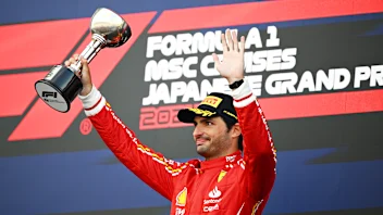 SUZUKA, JAPAN - APRIL 07: Third placed Carlos Sainz of Spain and Ferrari celebrates on the podium