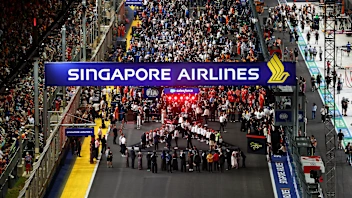 SINGAPORE, SINGAPORE - OCTOBER 11: Grid kids are lined up for the national anthem prior to the F1