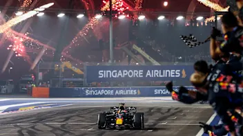 SINGAPORE, SINGAPORE - OCTOBER 11: Mechanics celebrate from the pit wall as Race winner Max