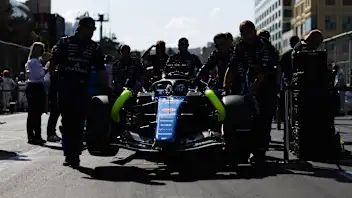 BAKU, AZERBAIJAN - SEPTEMBER 26: Mechanics push Alexander Albon of Thailand driving the (23)
