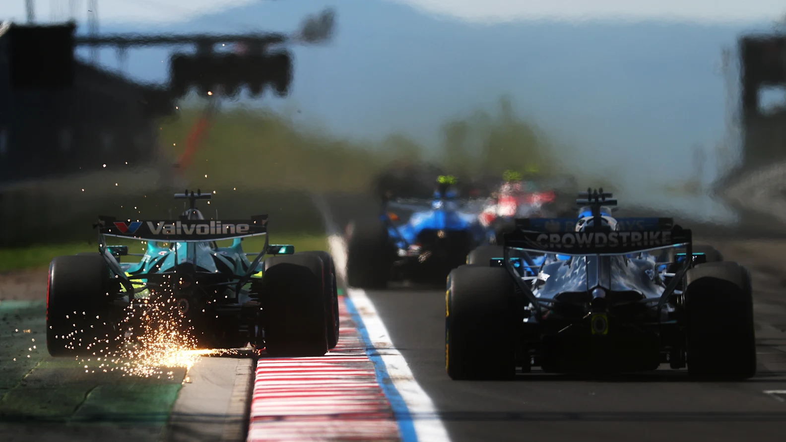 BUDAPEST, HUNGARY - JULY 26: Sparks fly behind Lance Stroll of Canada driving the (18) Aston Martin