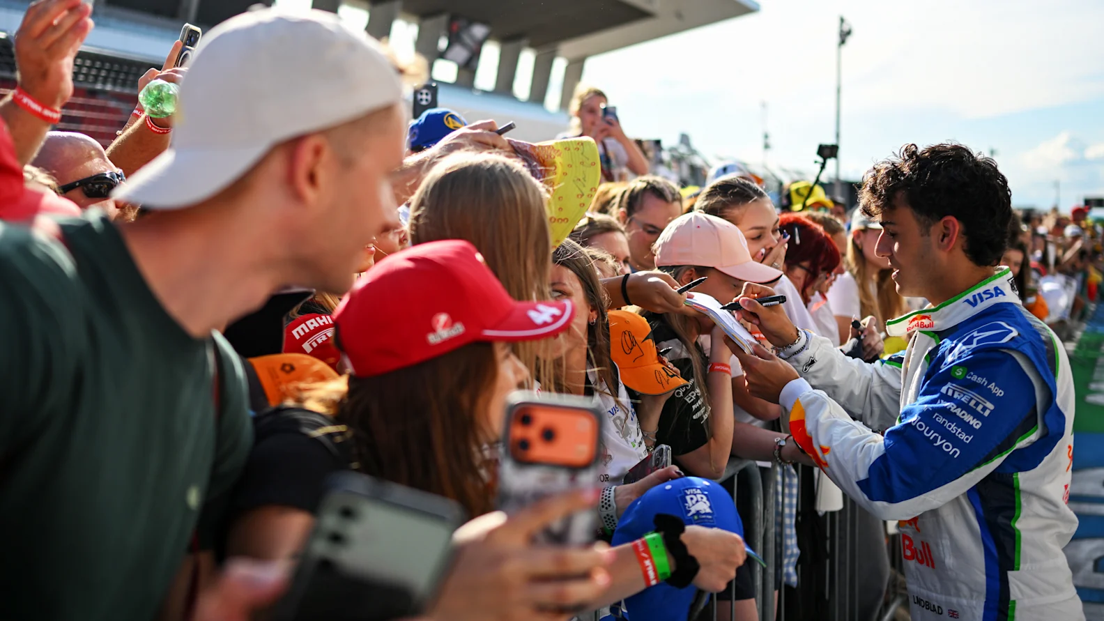 BUDAPEST, HUNGARY - JULY 23: Arvid Lindblad of Great Britain and Visa Cash App Racing Bulls signs