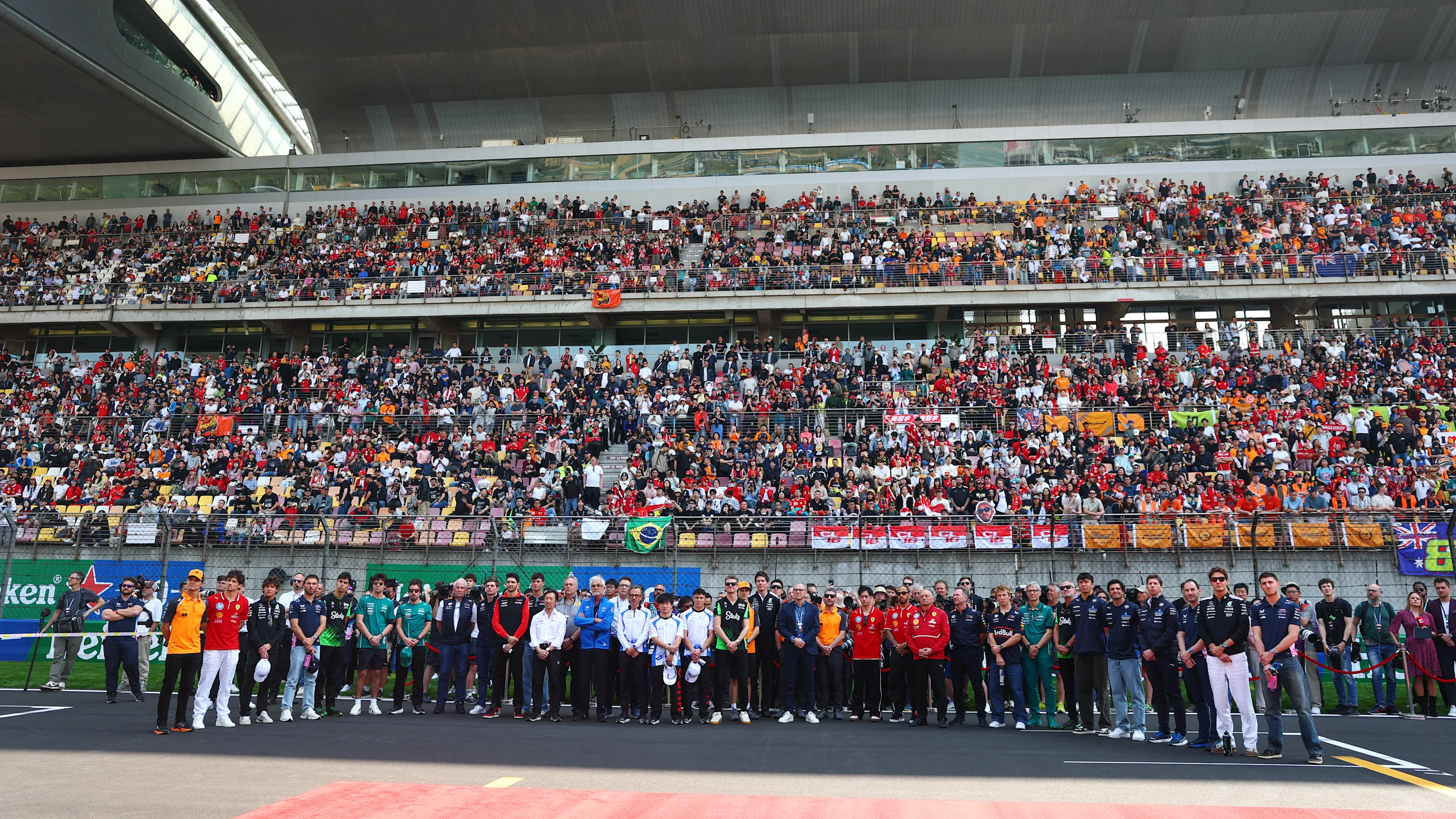 SHANGHAI, CHINA - MARCH 23: Drivers and team personnel gather in tribute to the late Eddie Jordan