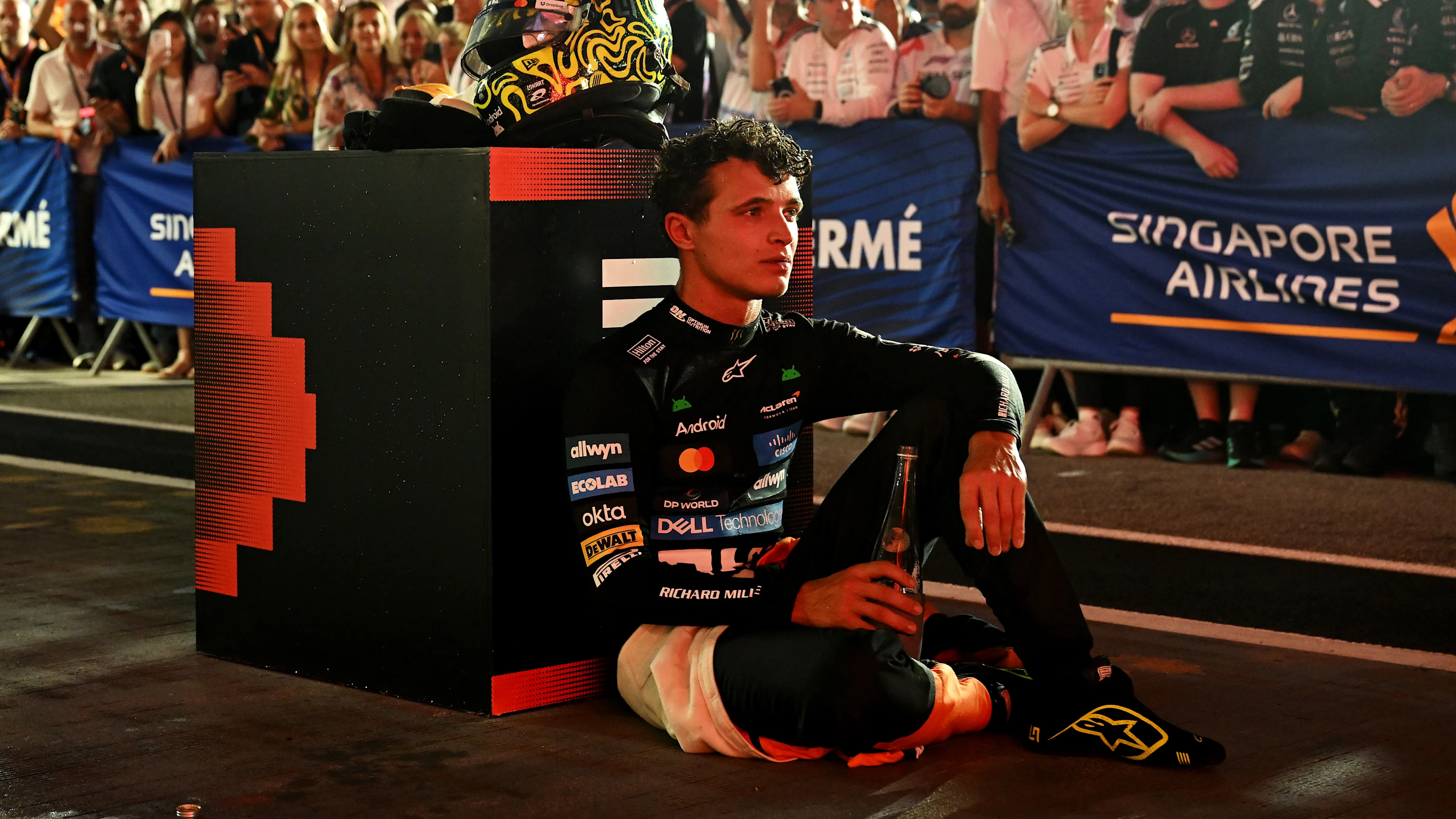 SINGAPORE, SINGAPORE - OCTOBER 05: Third placed Lando Norris of Great Britain and McLaren cools