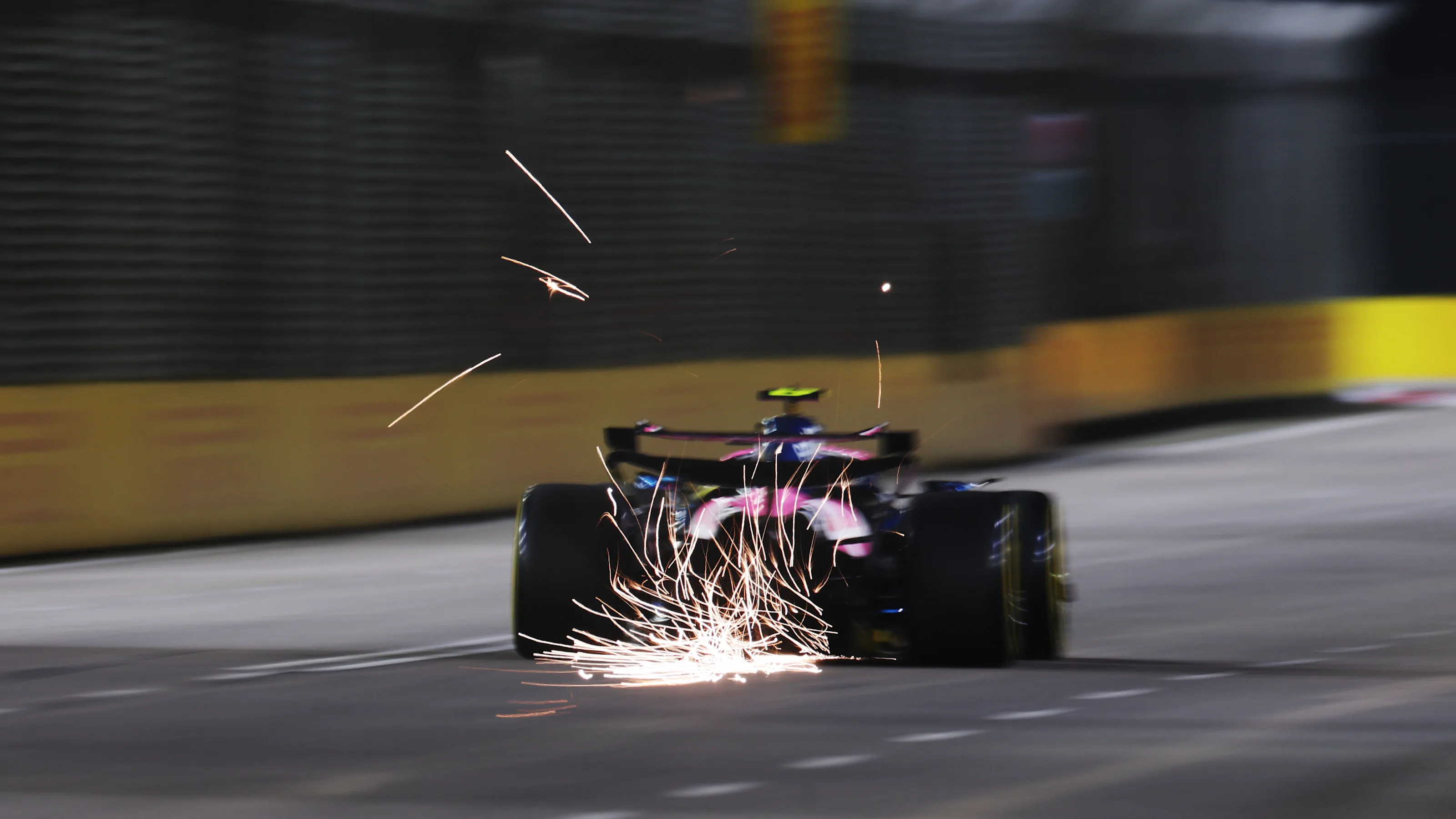 SINGAPORE, SINGAPORE - OCTOBER 03: Sparks fly behind Franco Colapinto of Argentina driving the (43)
