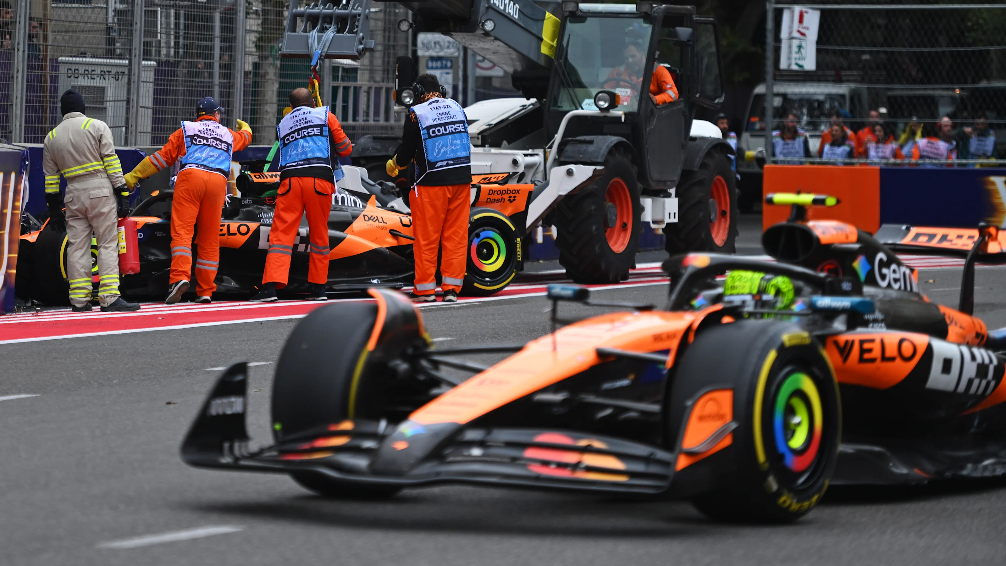 BAKU, AZERBAIJAN - SEPTEMBER 21: Marshals clear away the car of Oscar Piastri of Australia driving