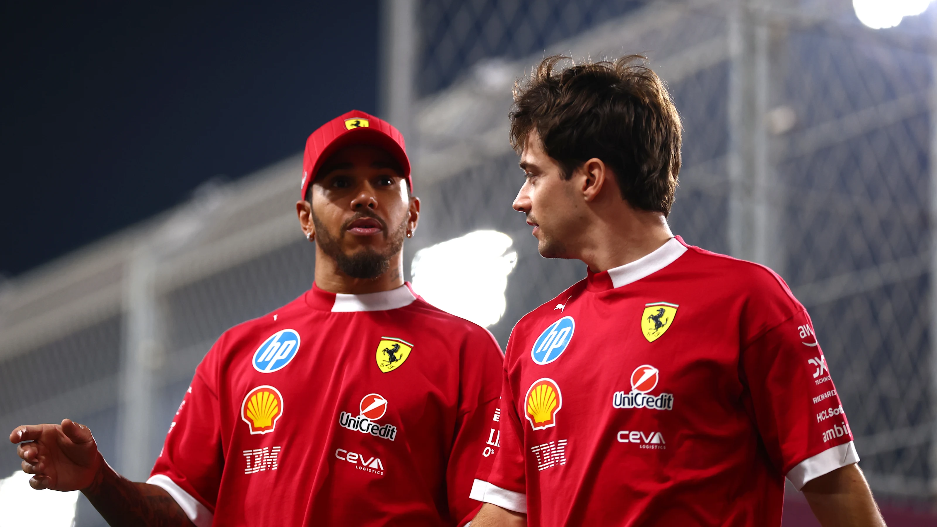 LUSAIL CITY, QATAR - NOVEMBER 30: Lewis Hamilton of Great Britain and Scuderia Ferrari and Charles