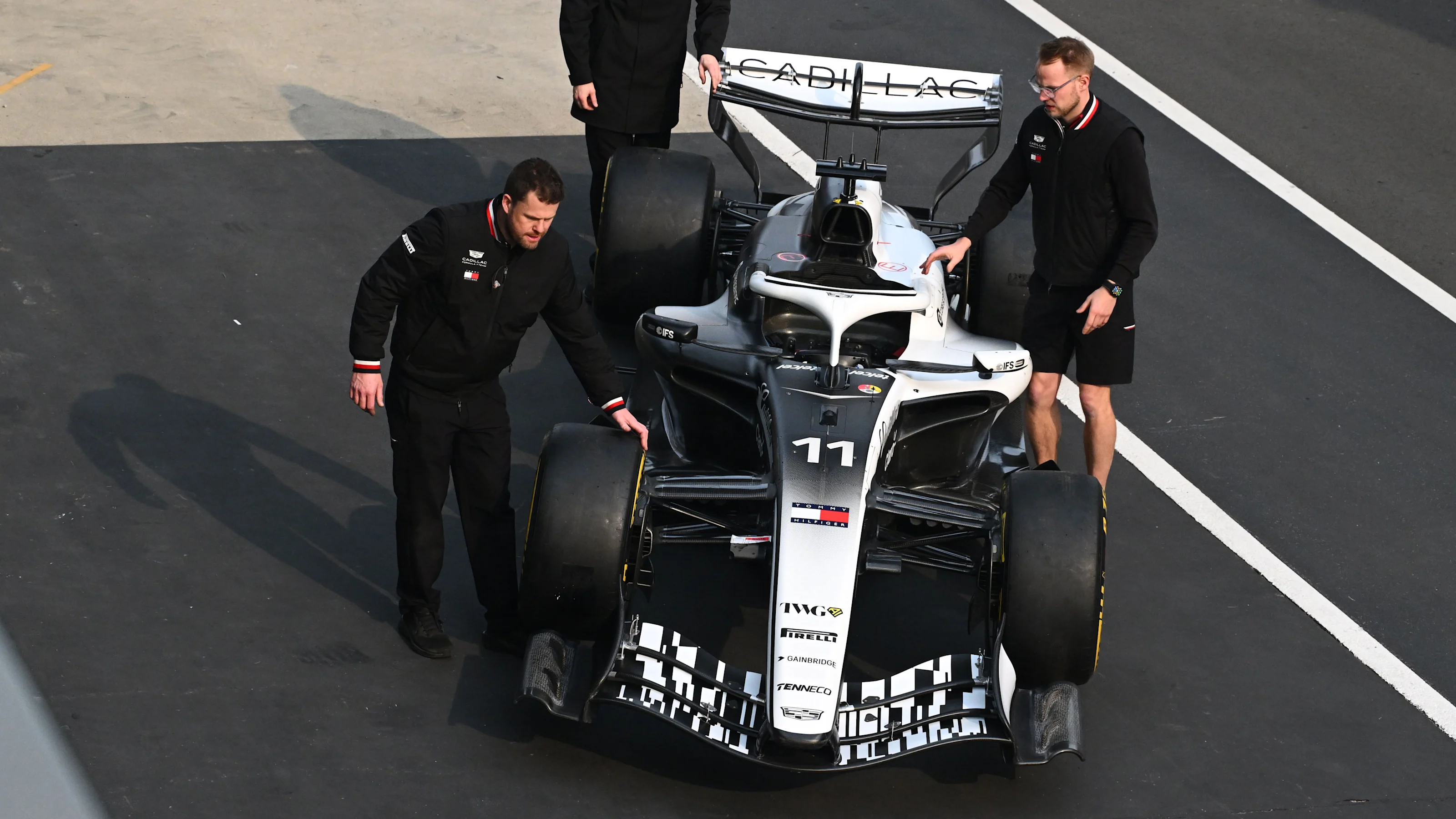 SHANGHAI, CHINA - MARCH 12: Mechanics with the car of Sergio Perez of Mexico and Cadillac F1 Team