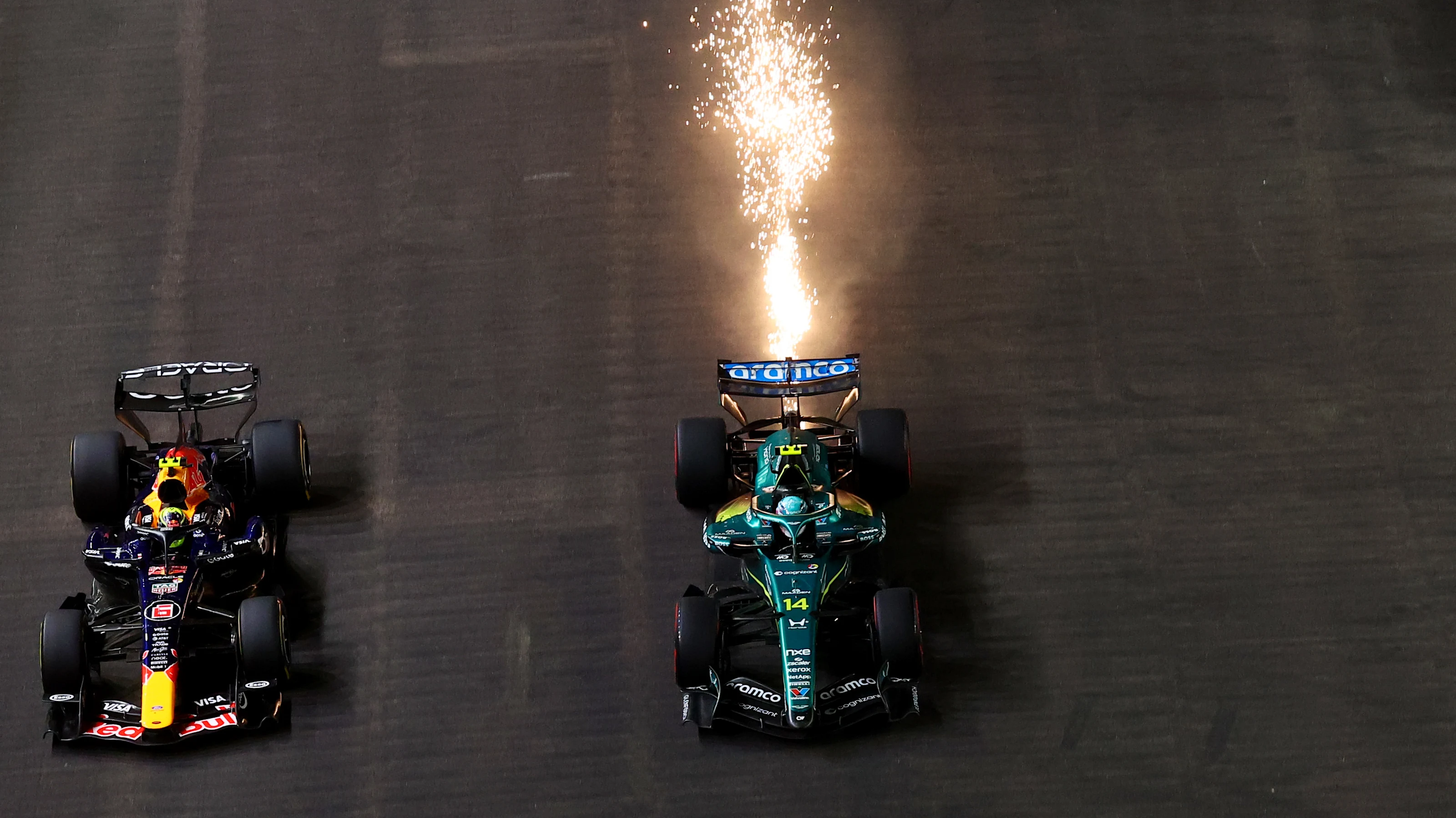 SINGAPORE, SINGAPORE - OCTOBER 11: Sparks fly behind Fernando Alonso of Spain driving the (14)