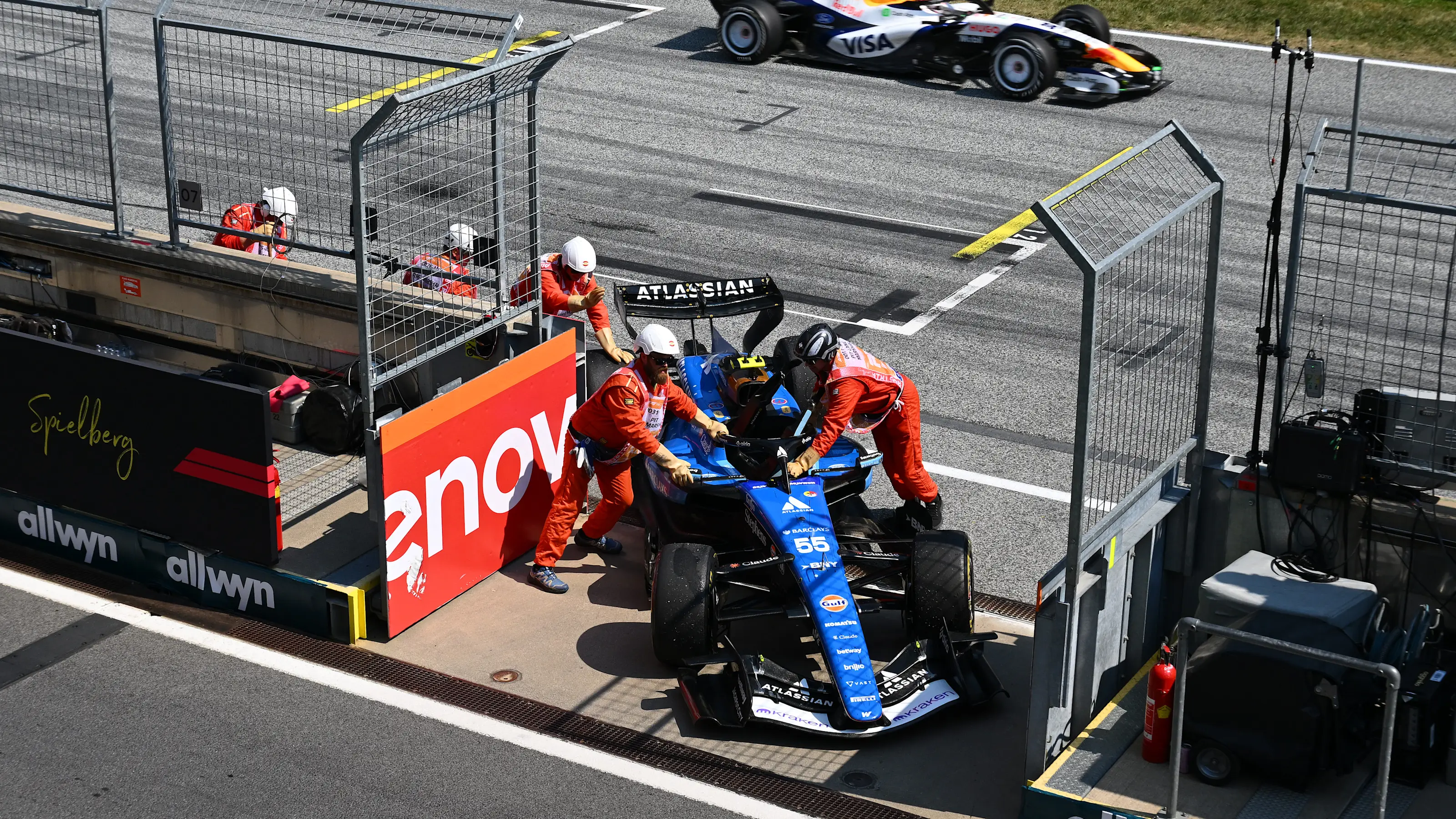 SPIELBERG, AUSTRIA - JUNE 28: Marshals move the car of Carlos Sainz of Spain and Williams from the