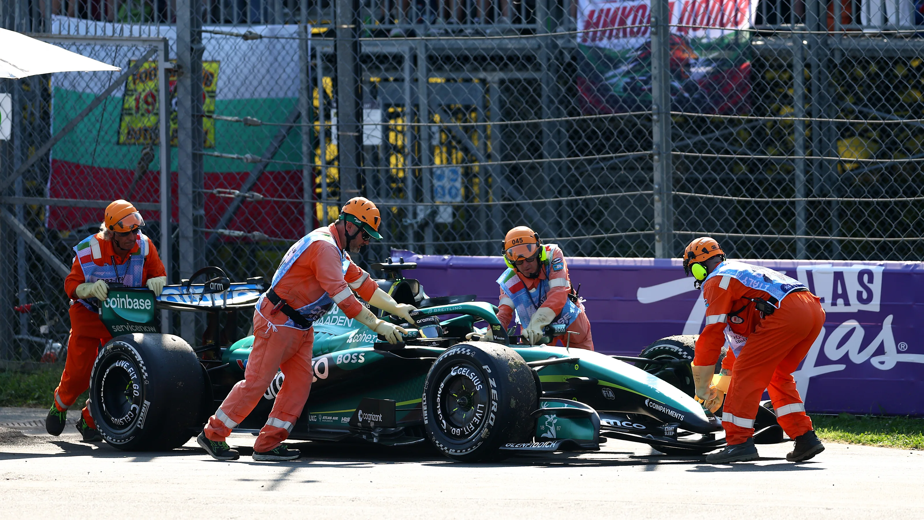 MONZA, ITALY - SEPTEMBER 06: Marshals clear away the car of Lance Stroll of Canada driving the (18)