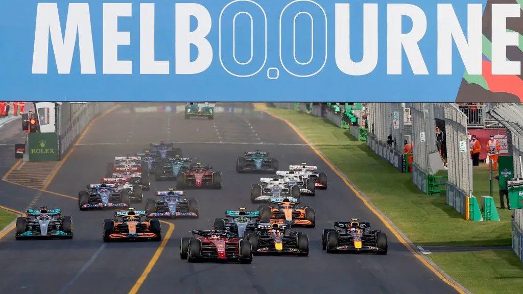 Ferrari's Monegasque driver Charles Leclerc (C) leads a pack at the start of the 2022 Formula One