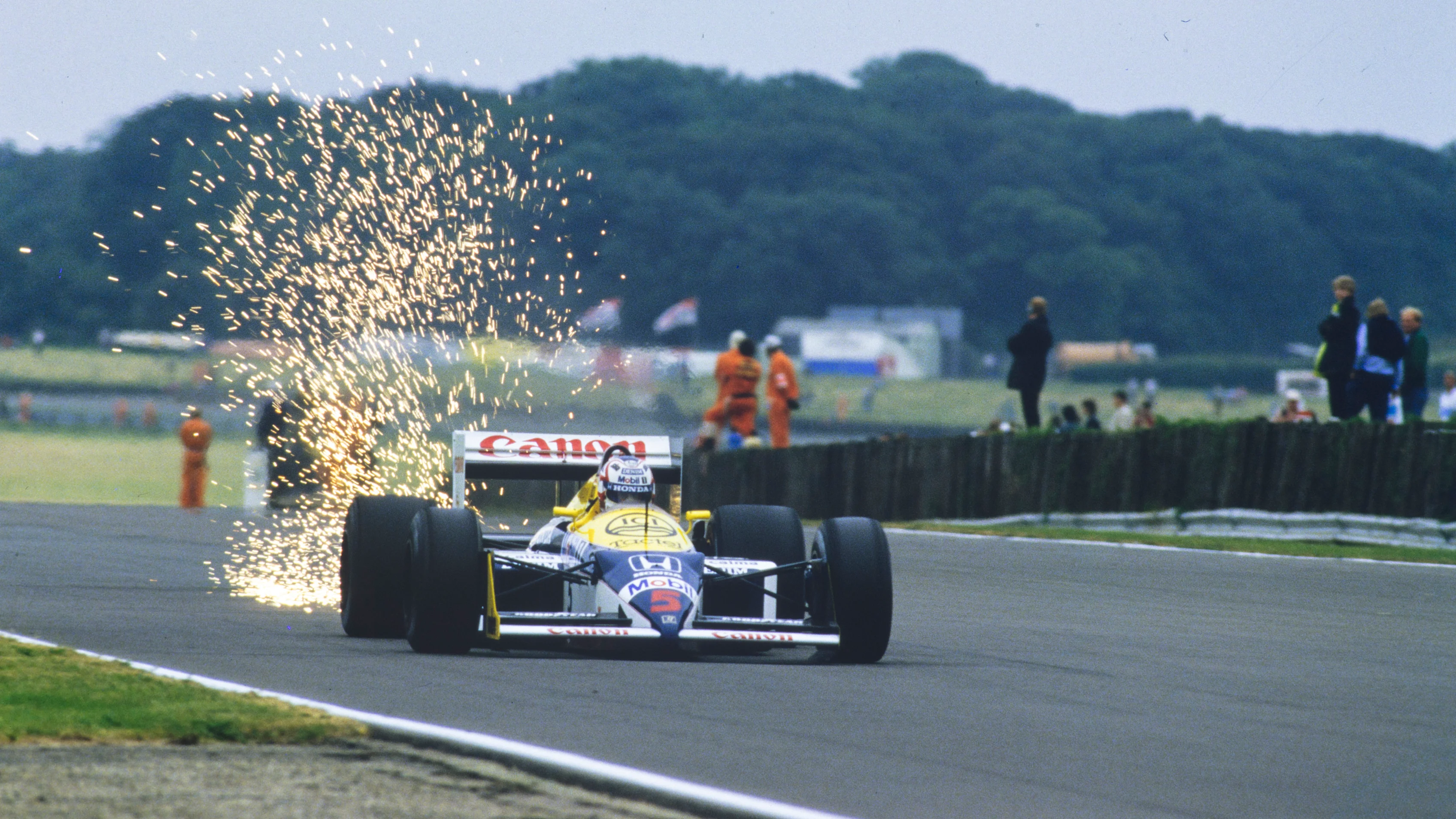 SILVERSTONE, UNITED KINGDOM - JULY 12: Nigel Mansell, Williams FW11B Honda, sends up a shower of