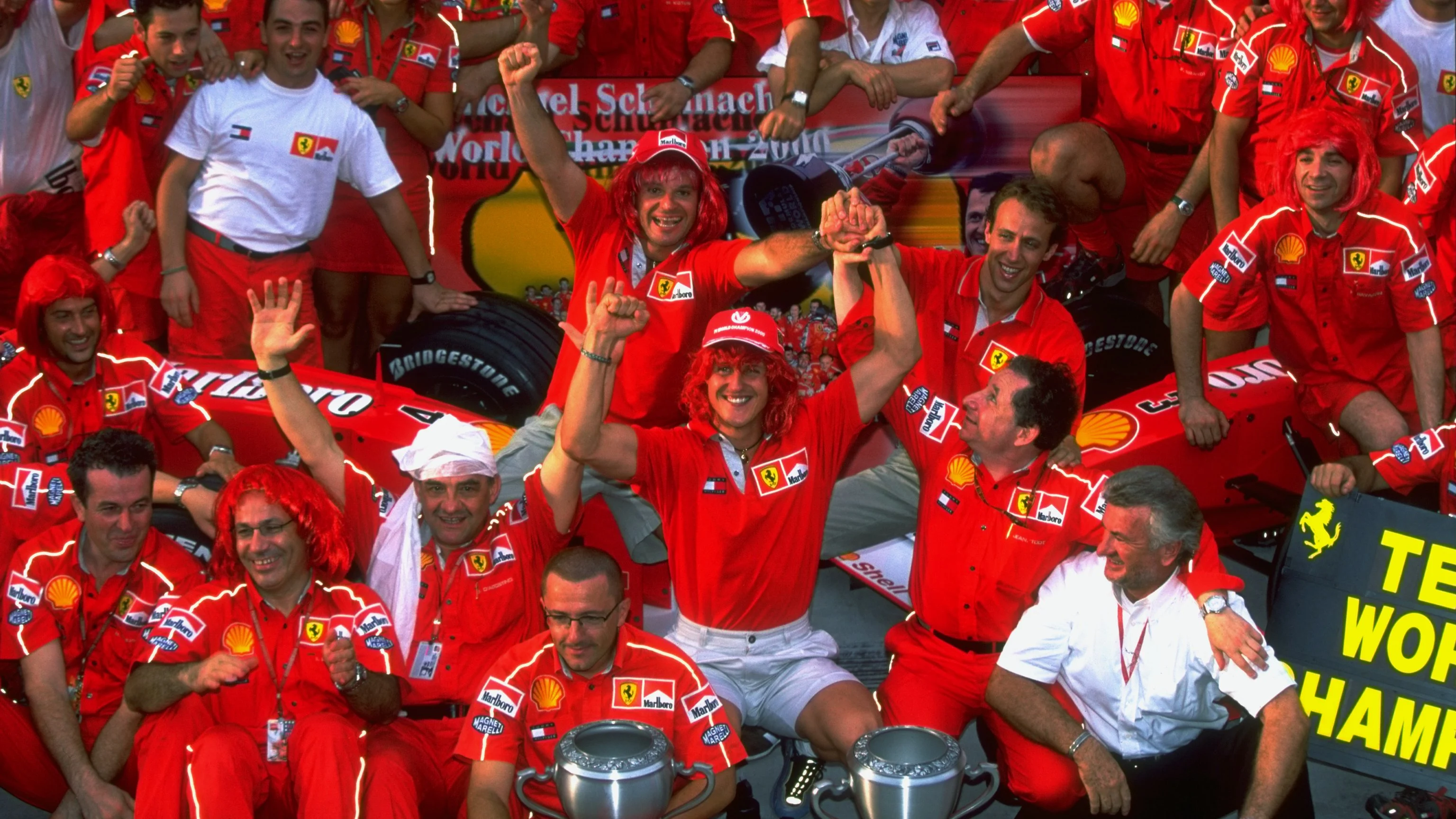 22 Oct 2000: Michael Schumacher of Germany and Ferrari celebrates winning with the Ferrari team