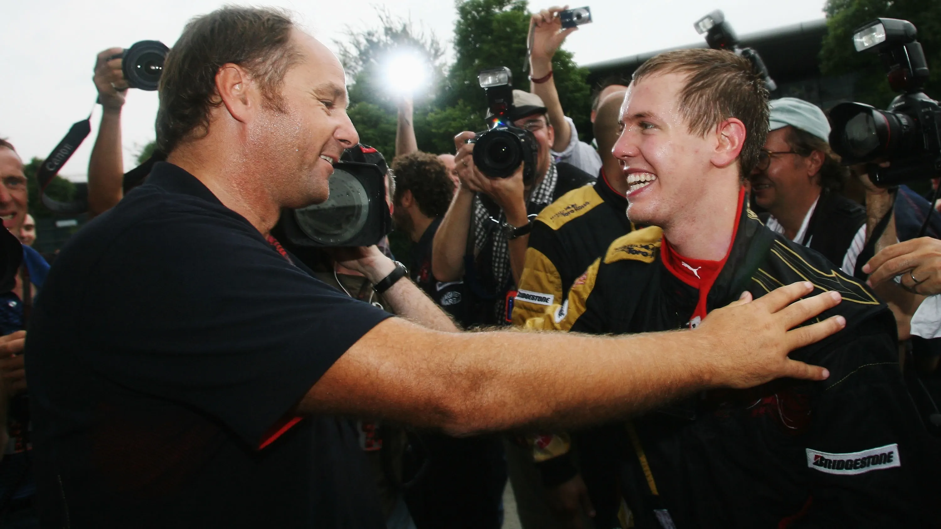 SHANGHAI, CHINA - OCTOBER 07: Sebastian Vettel (R) of Germany and Scuderia Toro Rosso celebrates