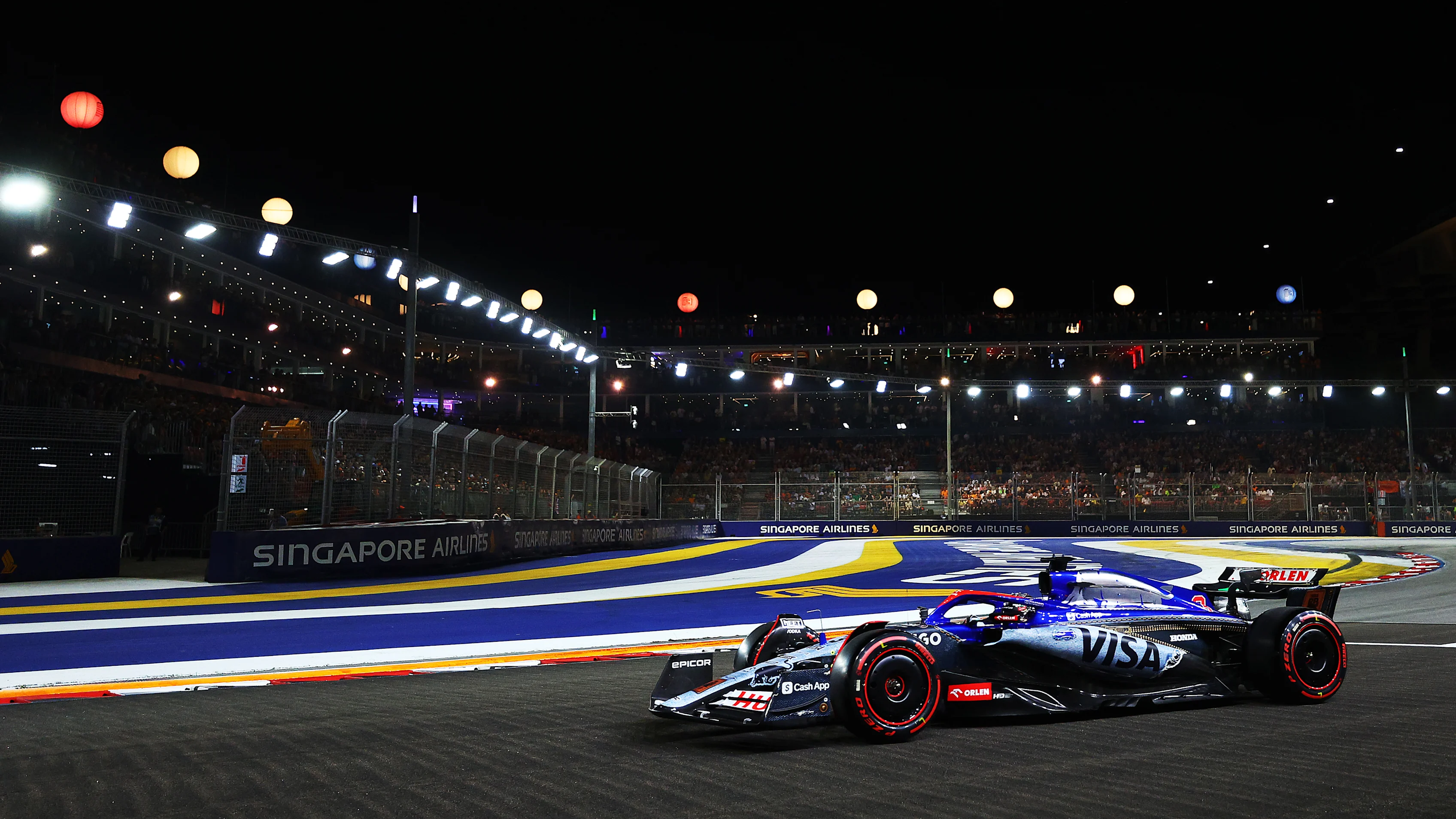 SINGAPORE, SINGAPORE - SEPTEMBER 21: Daniel Ricciardo of Australia driving the (3) Visa Cash App RB