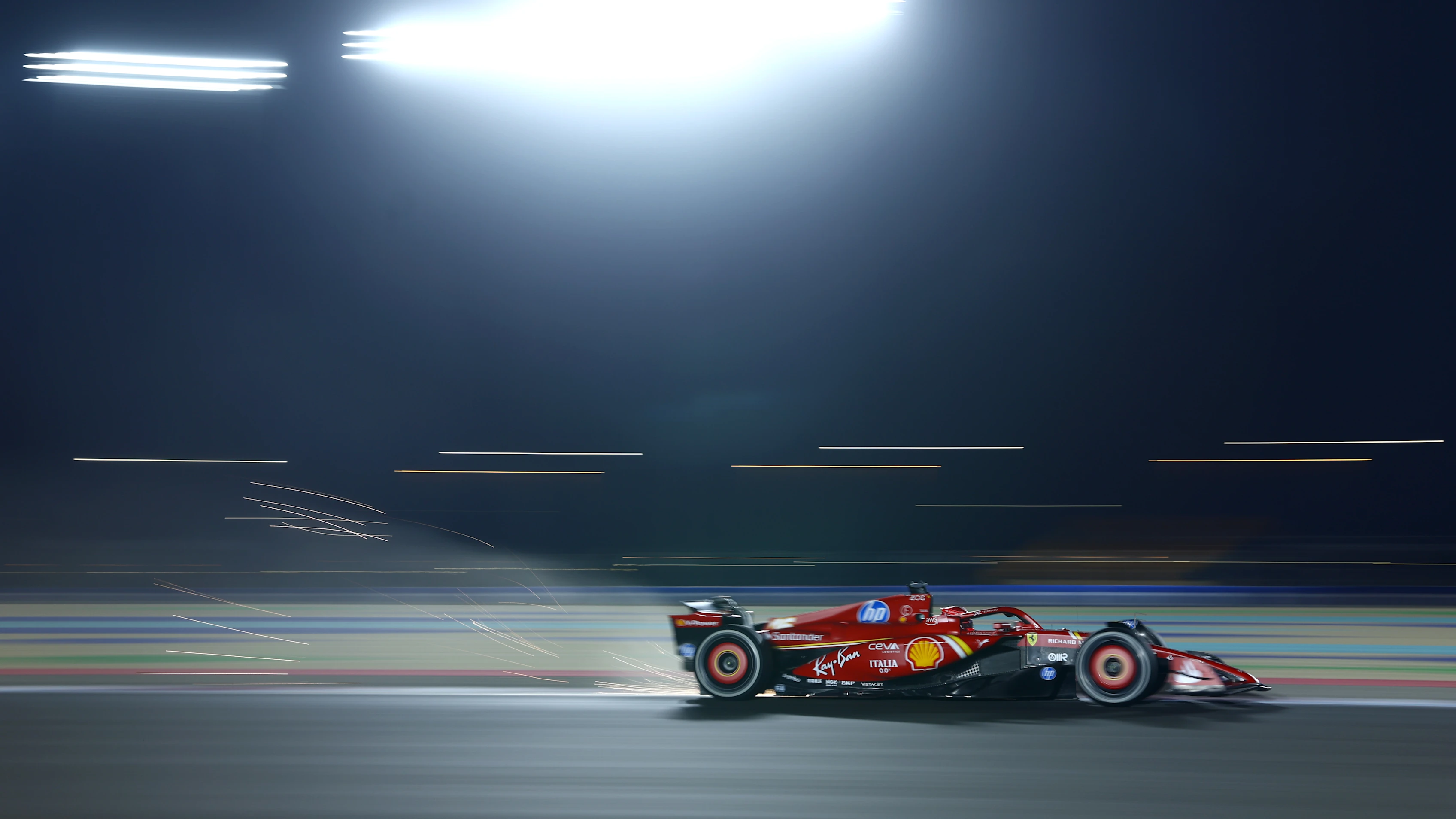 LUSAIL CITY, QATAR - NOVEMBER 29: Sparks fly behind Charles Leclerc of Monaco driving the (16)