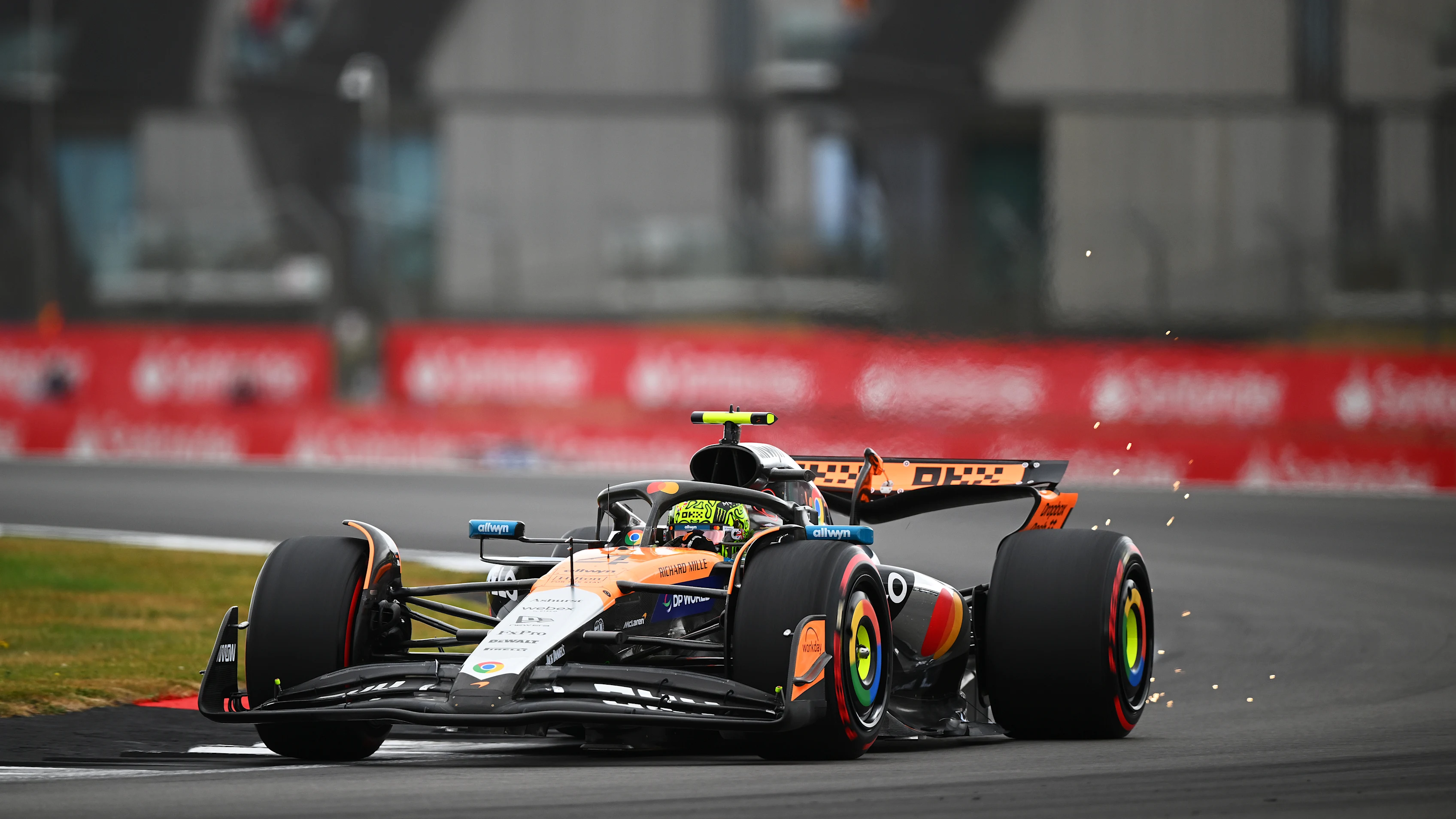 NORTHAMPTON, ENGLAND - JULY 05: Sparks fly behind Lando Norris of Great Britain driving the (4)