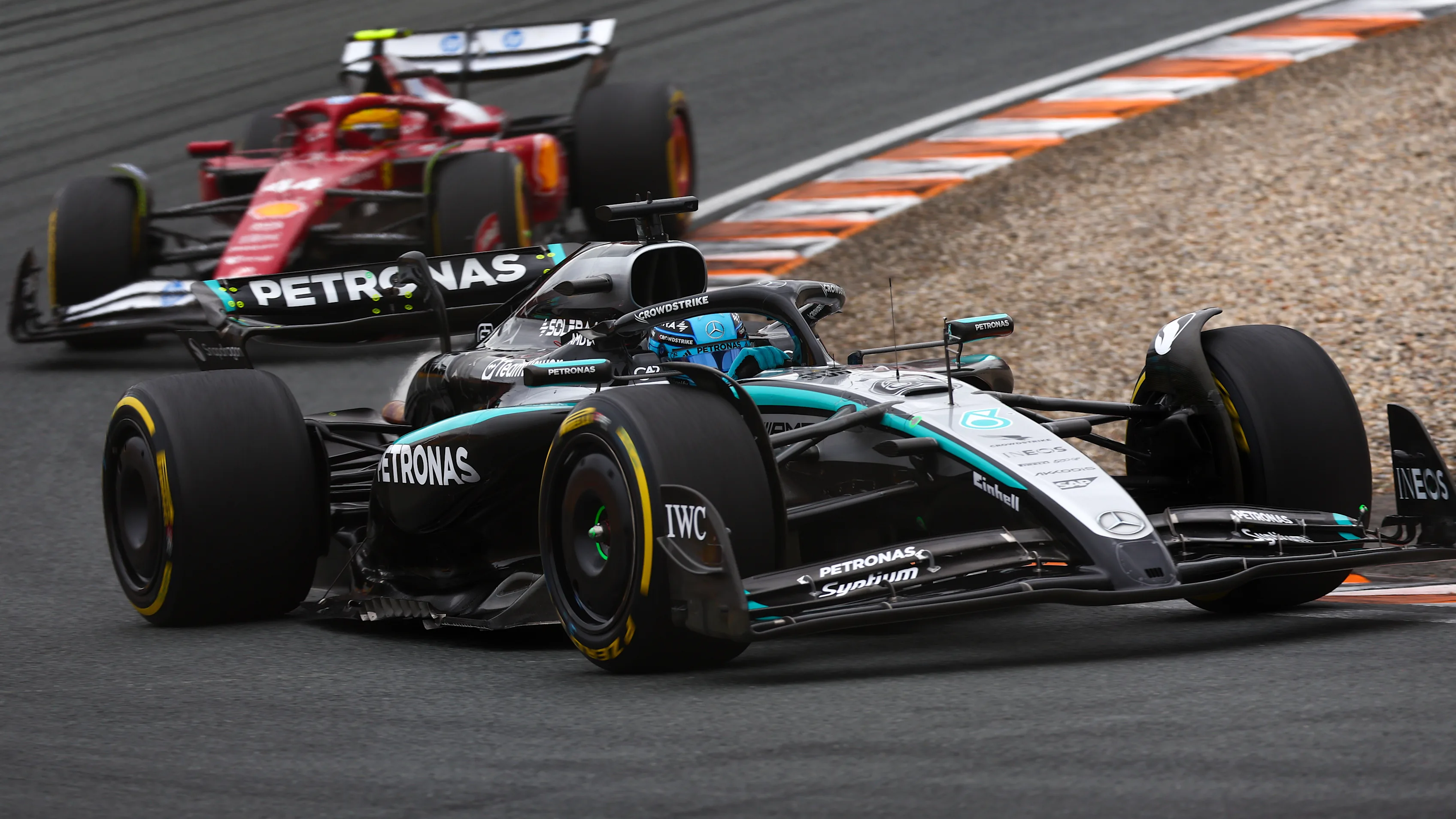 ZANDVOORT, NETHERLANDS - AUGUST 31: George Russell of Great Britain driving the (63) Mercedes AMG Petronas F1 Team W16 leads Lewis Hamilton of Great Britain driving the (44) Scuderia Ferrari SF-25 on track during the F1 Grand Prix of Netherlands at Circuit Zandvoort on August 31, 2025 in Zandvoort, Netherlands. (Photo by Joe Portlock/Getty Images)