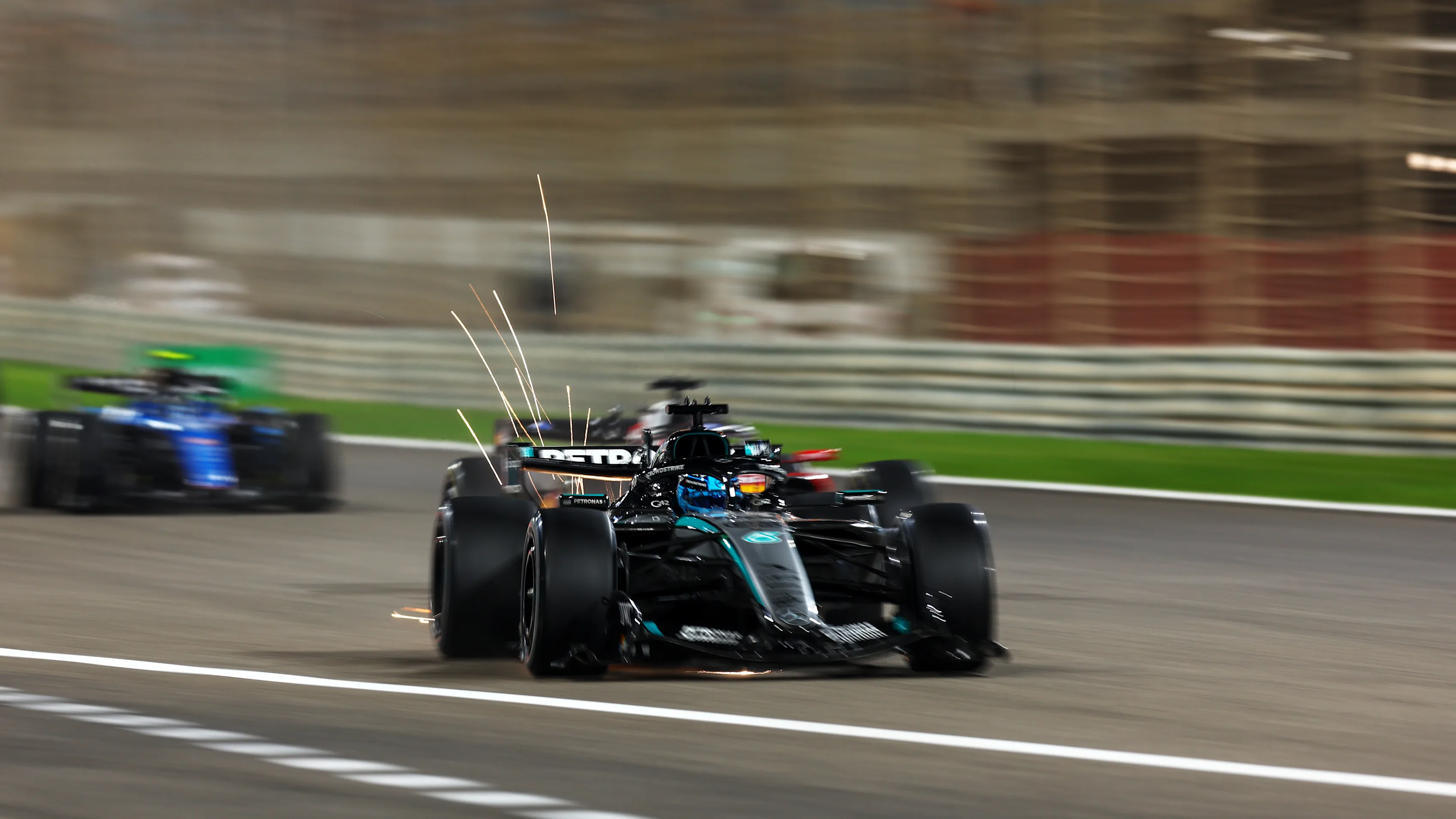 BAHRAIN, BAHRAIN - FEBRUARY 20: Sparks fly behind George Russell of Great Britain driving the (63)