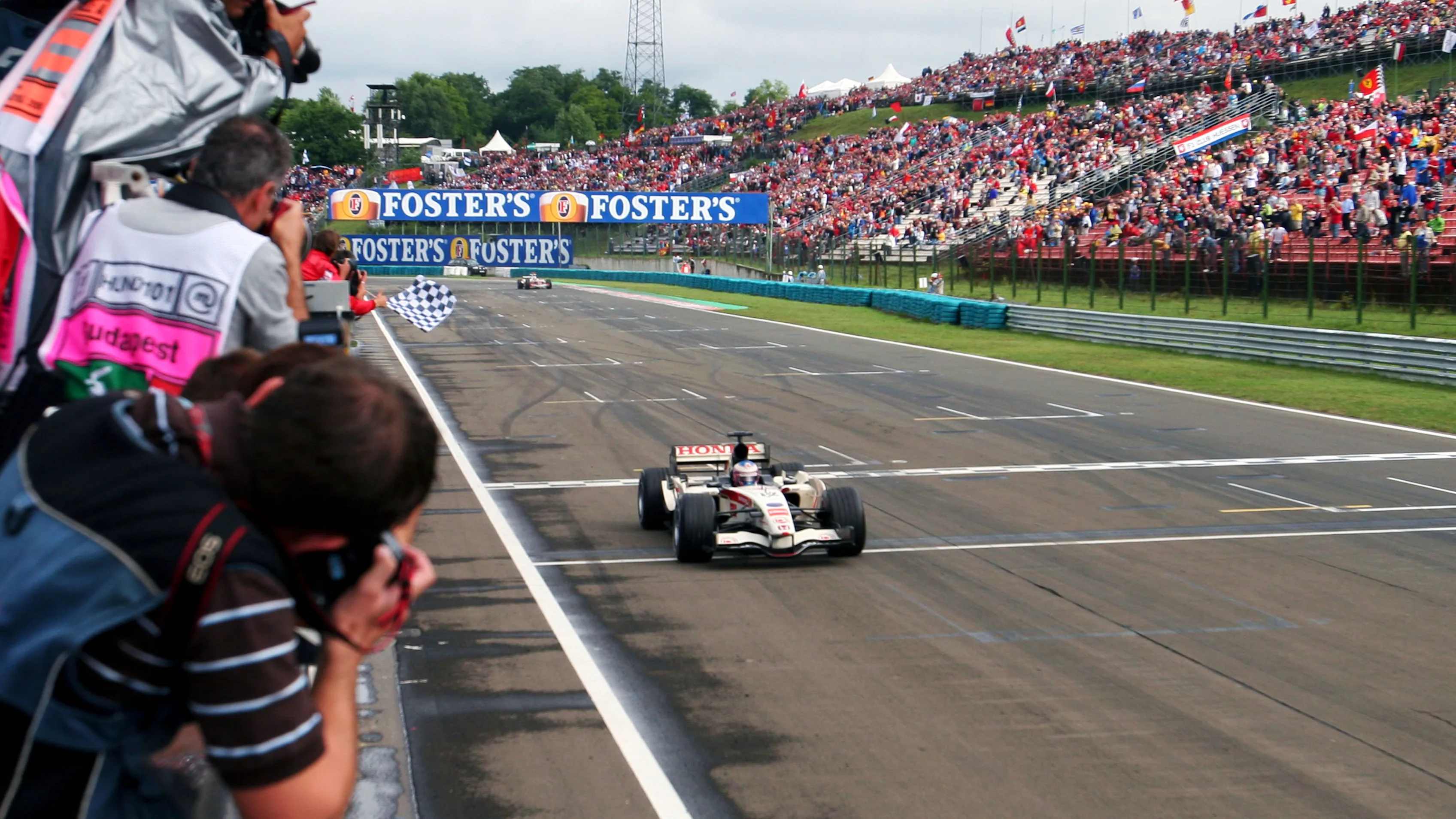Race winner Jenson Button (GBR) Honda Racing RA106 crosses the line. Formula One World