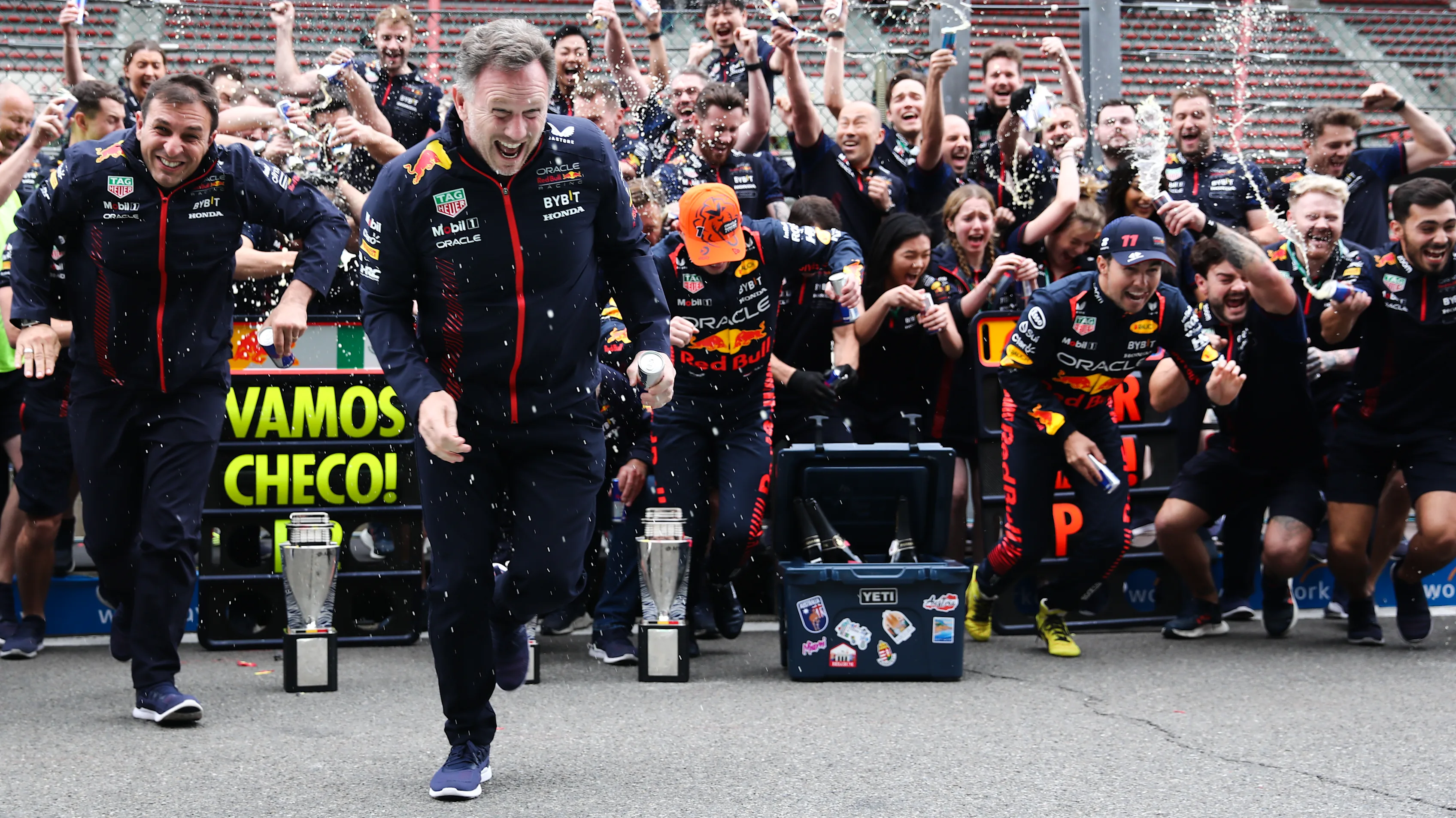 Christian Horner, Max Verstappen and Sergio Perez of Red Bull Racing celebrate with the team after