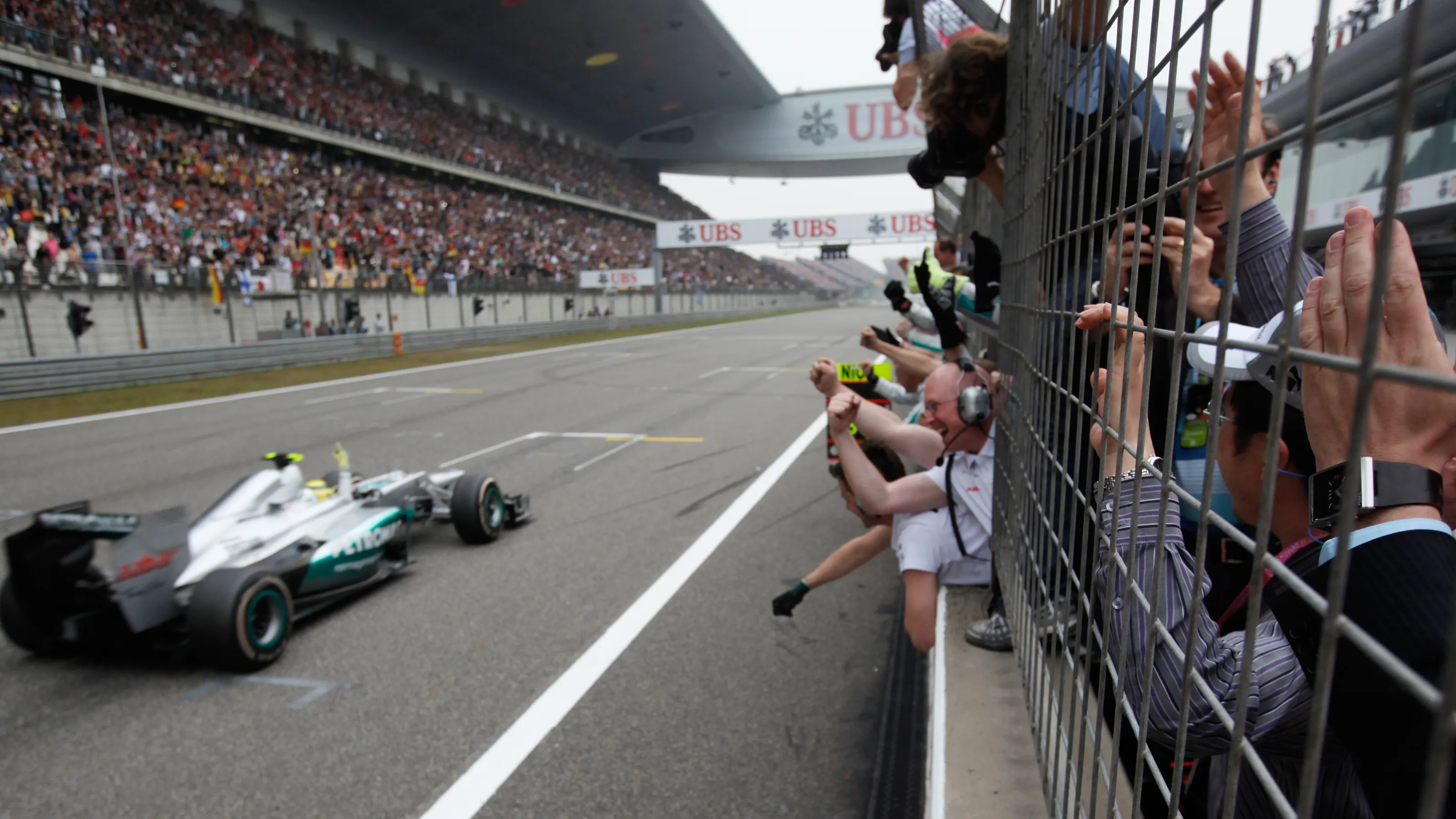 Mercedes-AMG driver Nico Rosberg of Germany is cheered by crew members in the pit wall after