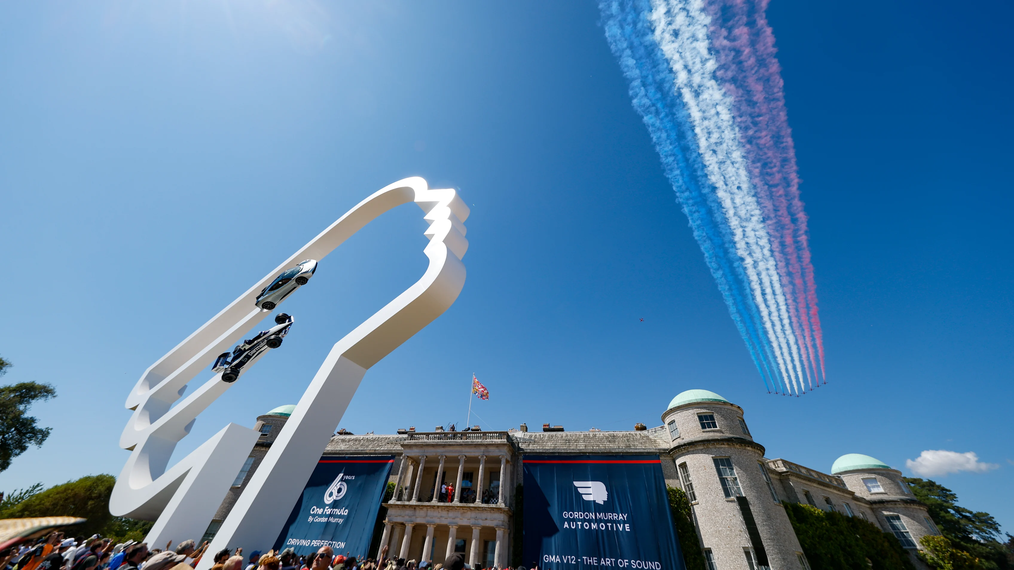 CHICHESTER, ENGLAND - JULY 13: An air display flies over the venue during the Goodwood Festival of