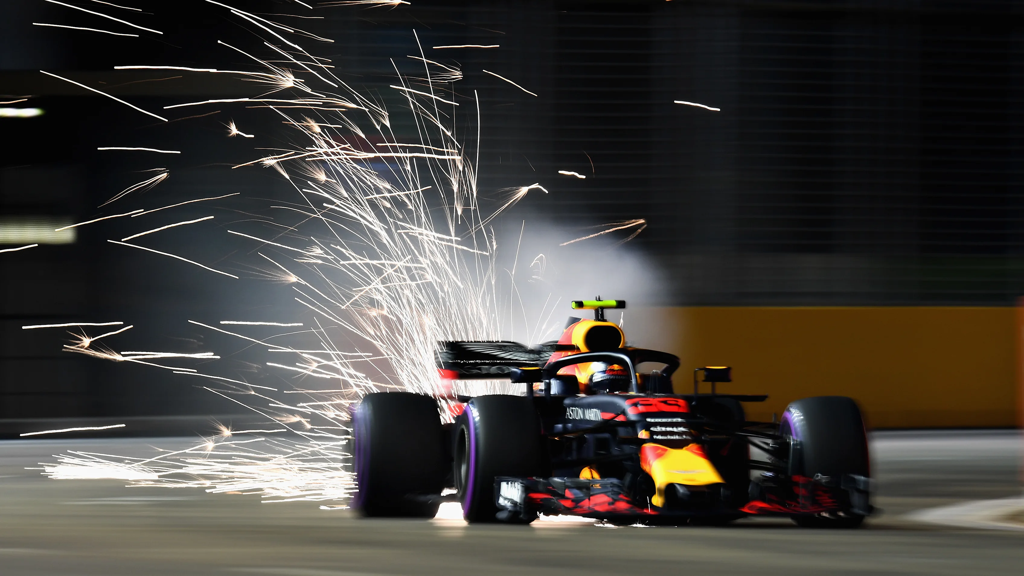 SINGAPORE - SEPTEMBER 14:  Sparks fly behind Max Verstappen of the Netherlands driving the (33)