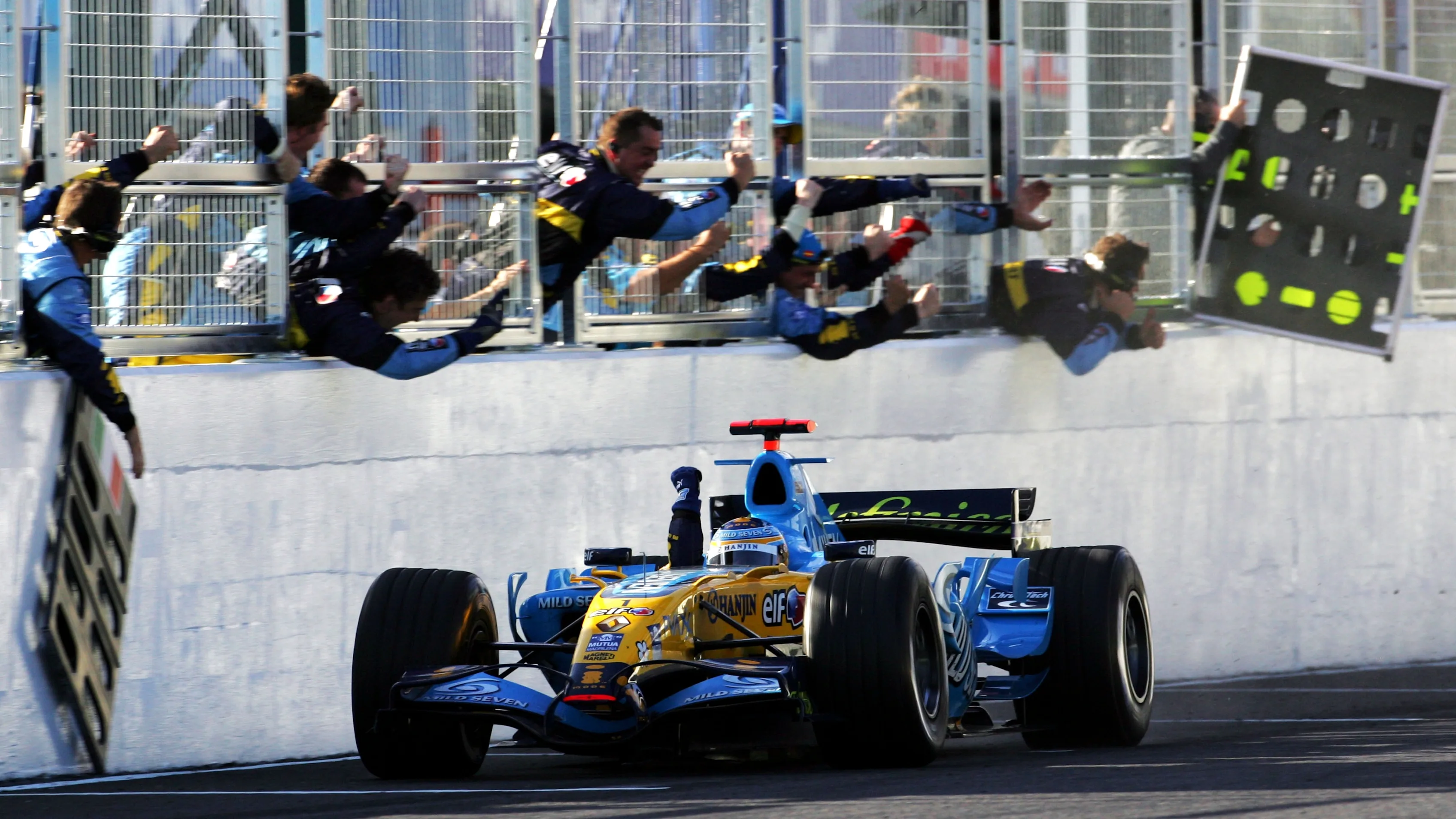 Race winner Fernando Alonso (ESP) Renault R26 takes the chequered flag. Formula One World