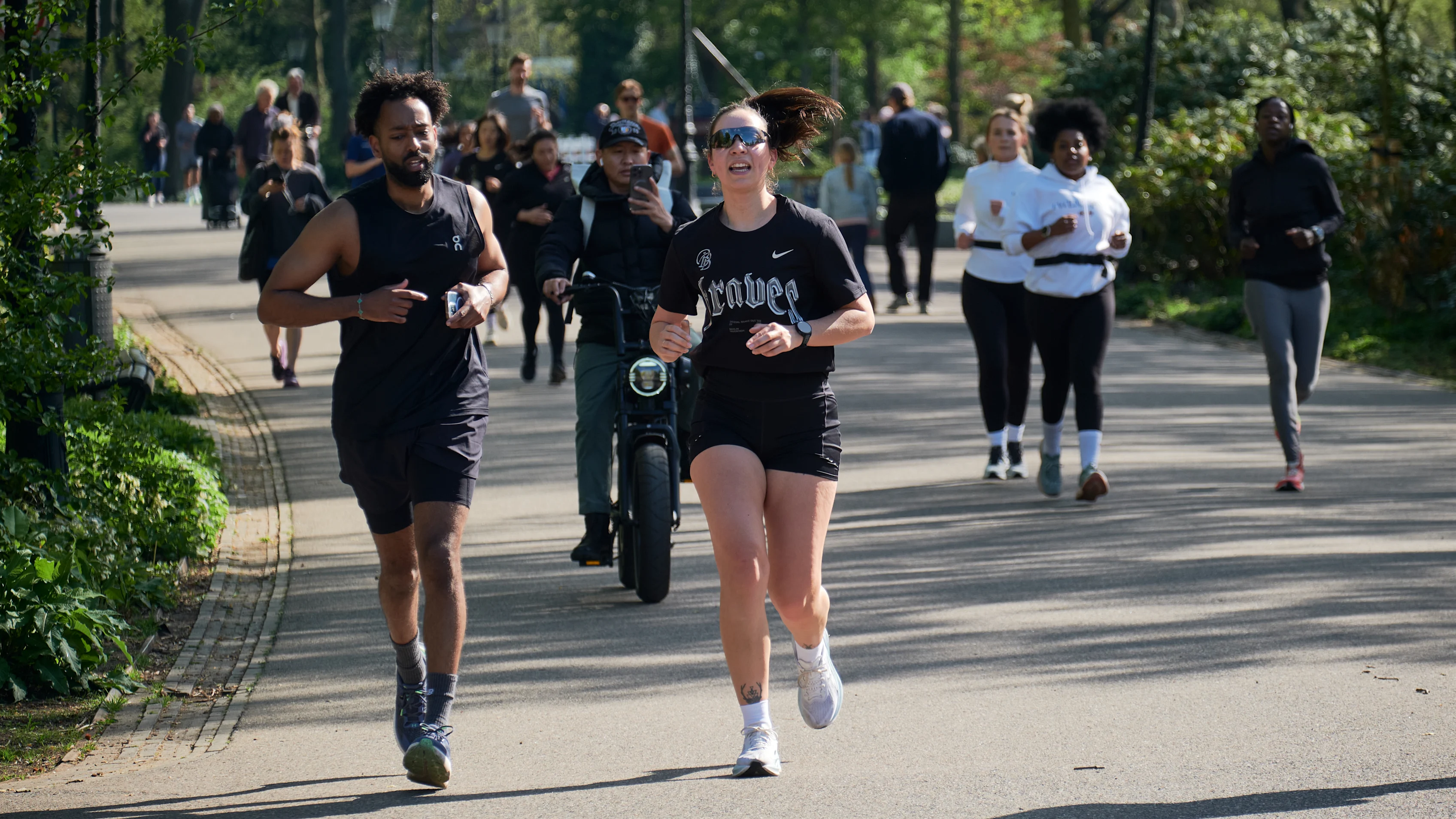 AMSTERDAM, NETHERLANDS - APRIL 19: Joggers run through Oosterpark on April 19, 2025 in Amsterdam,