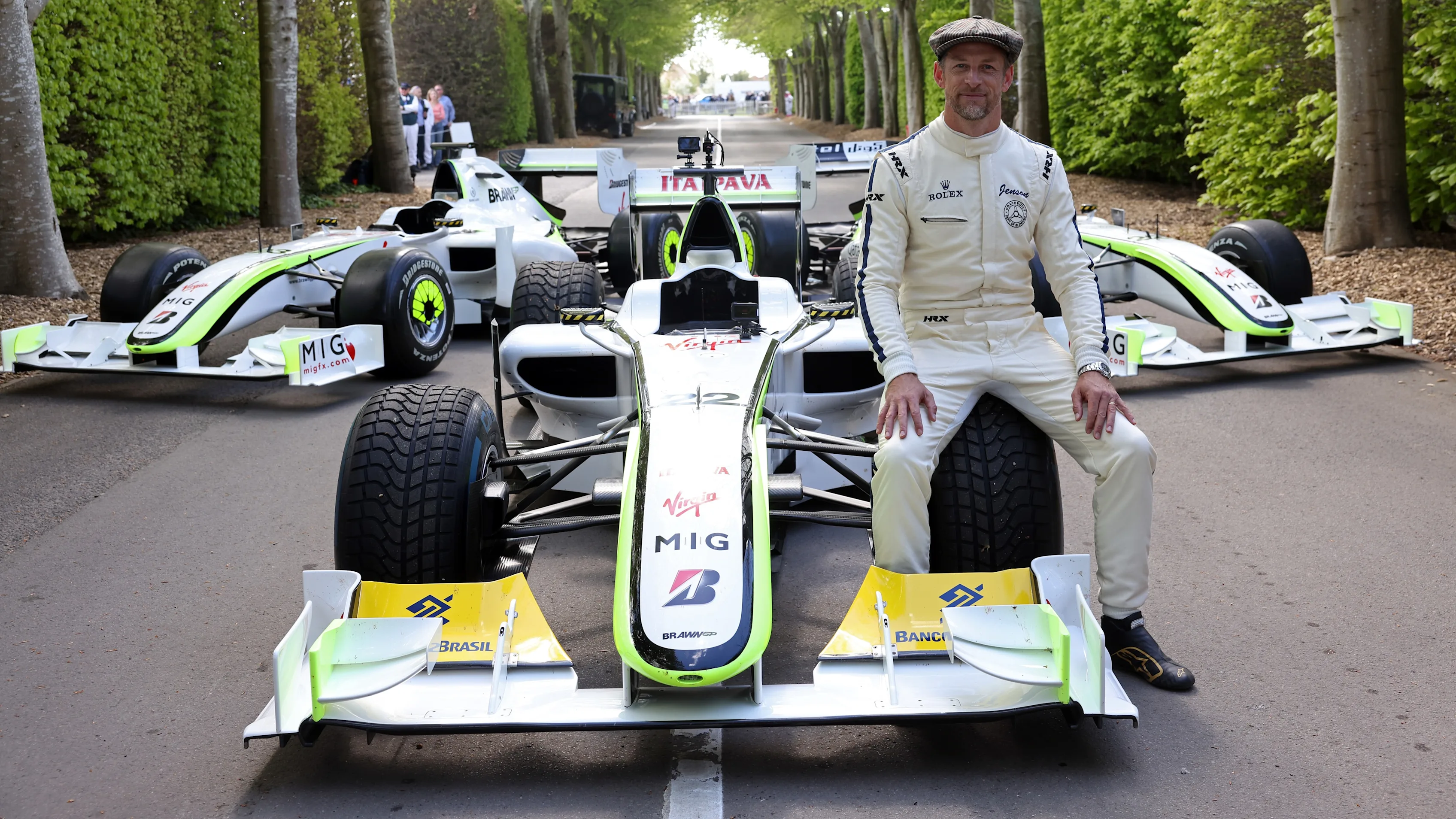 Jenson Button with his 2009 Formula 1 World Championship‑winning Brawn BGP 001 after an on track