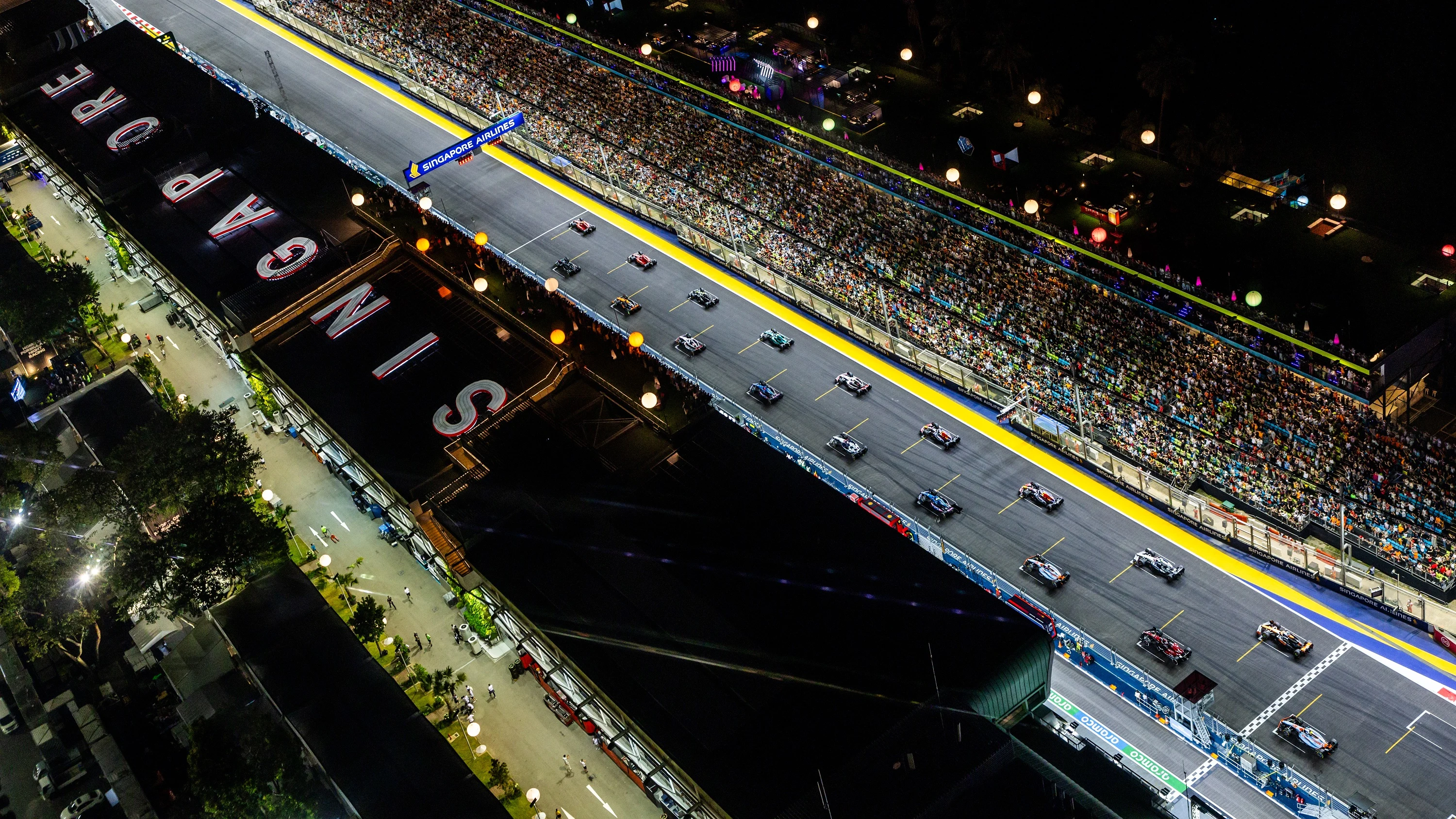 SINGAPORE, SINGAPORE - SEPTEMBER 17: A general view as cars leave the grid at the start of the race