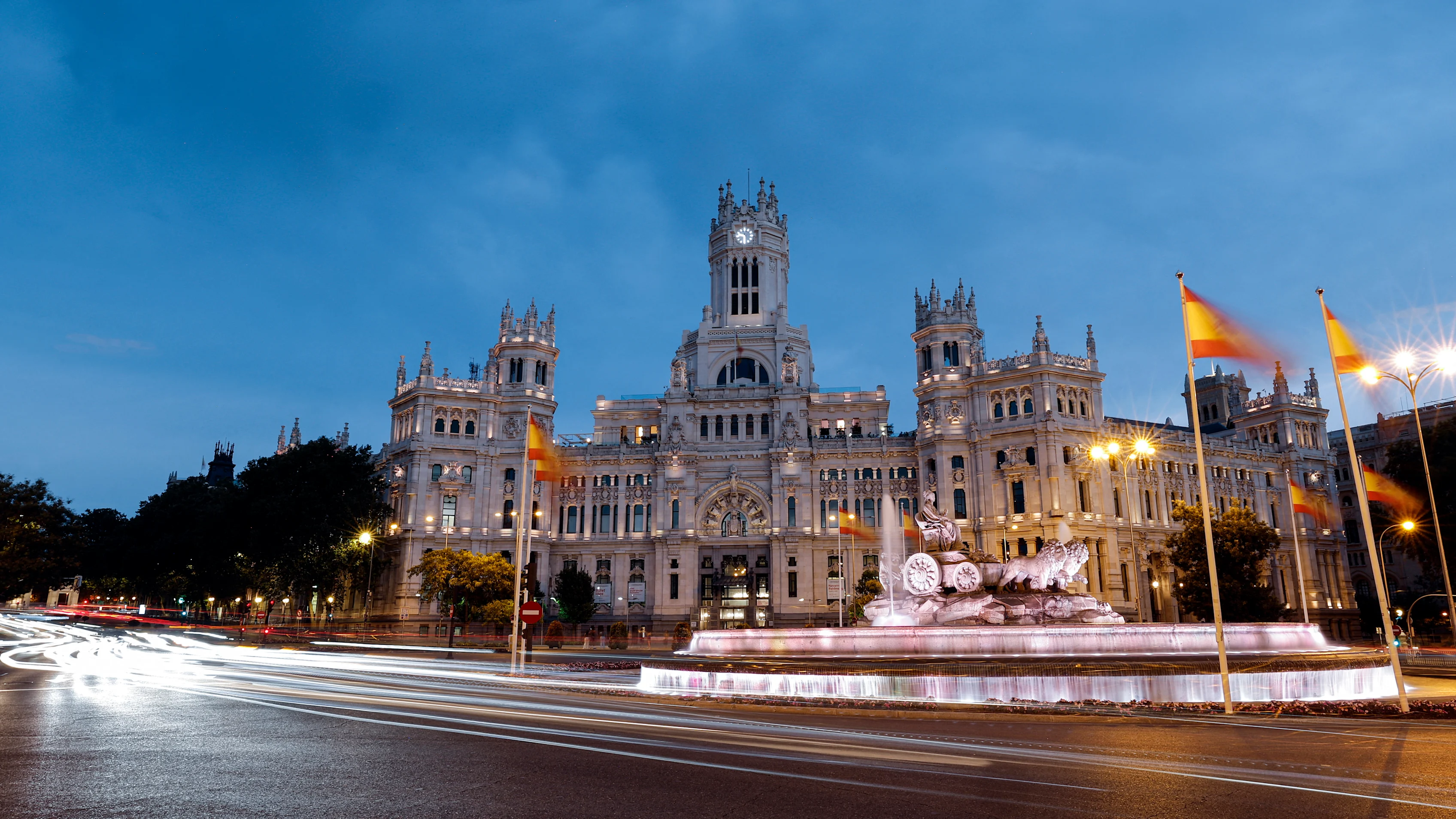 General view shows the Cibeles fountain and Cibeles Palace in Madrid illuminated at dusk on July