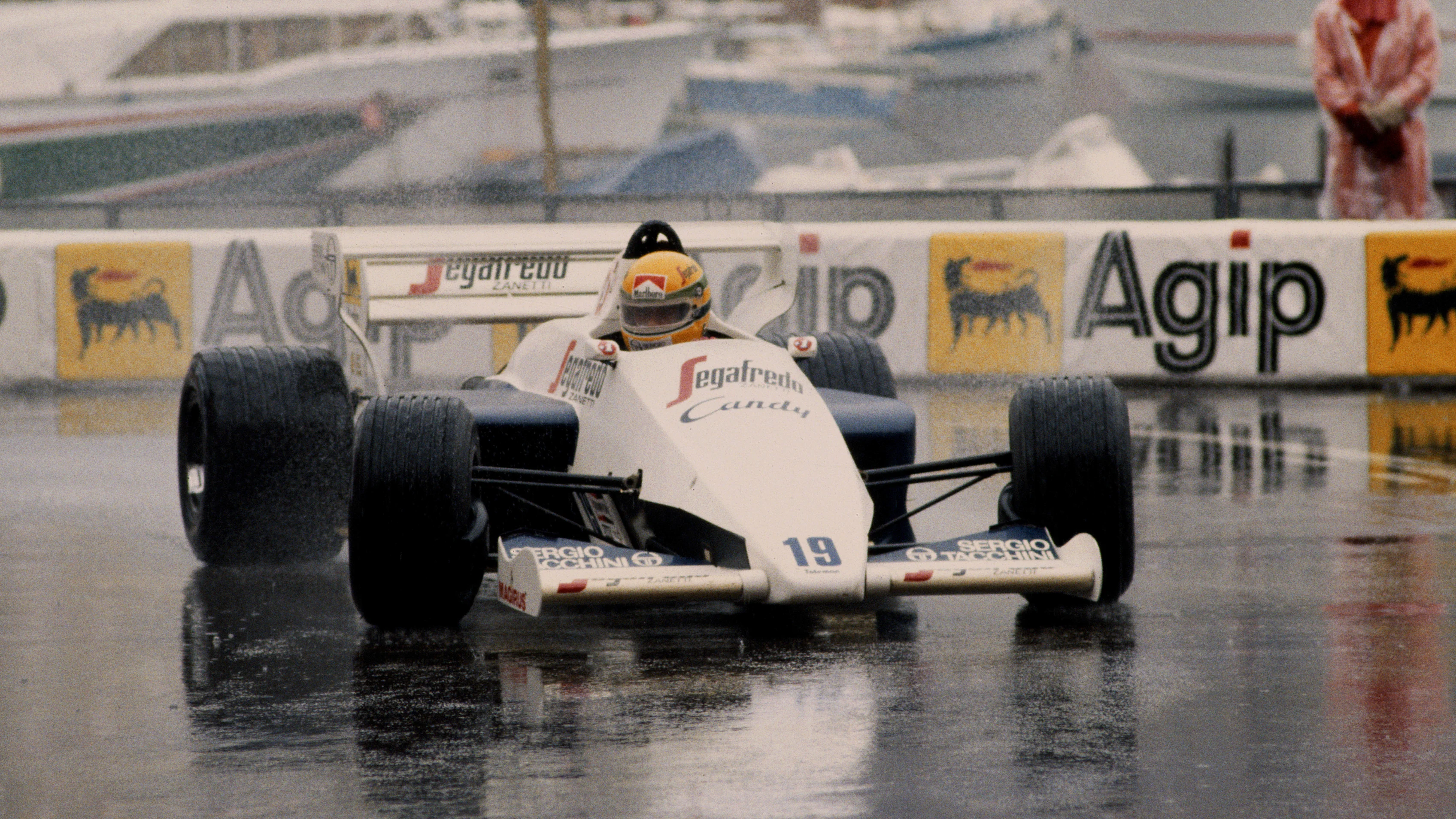 Ayrton Senna of Brazil drives the #19 Toleman-Hart TG184 in the rain to second place during the