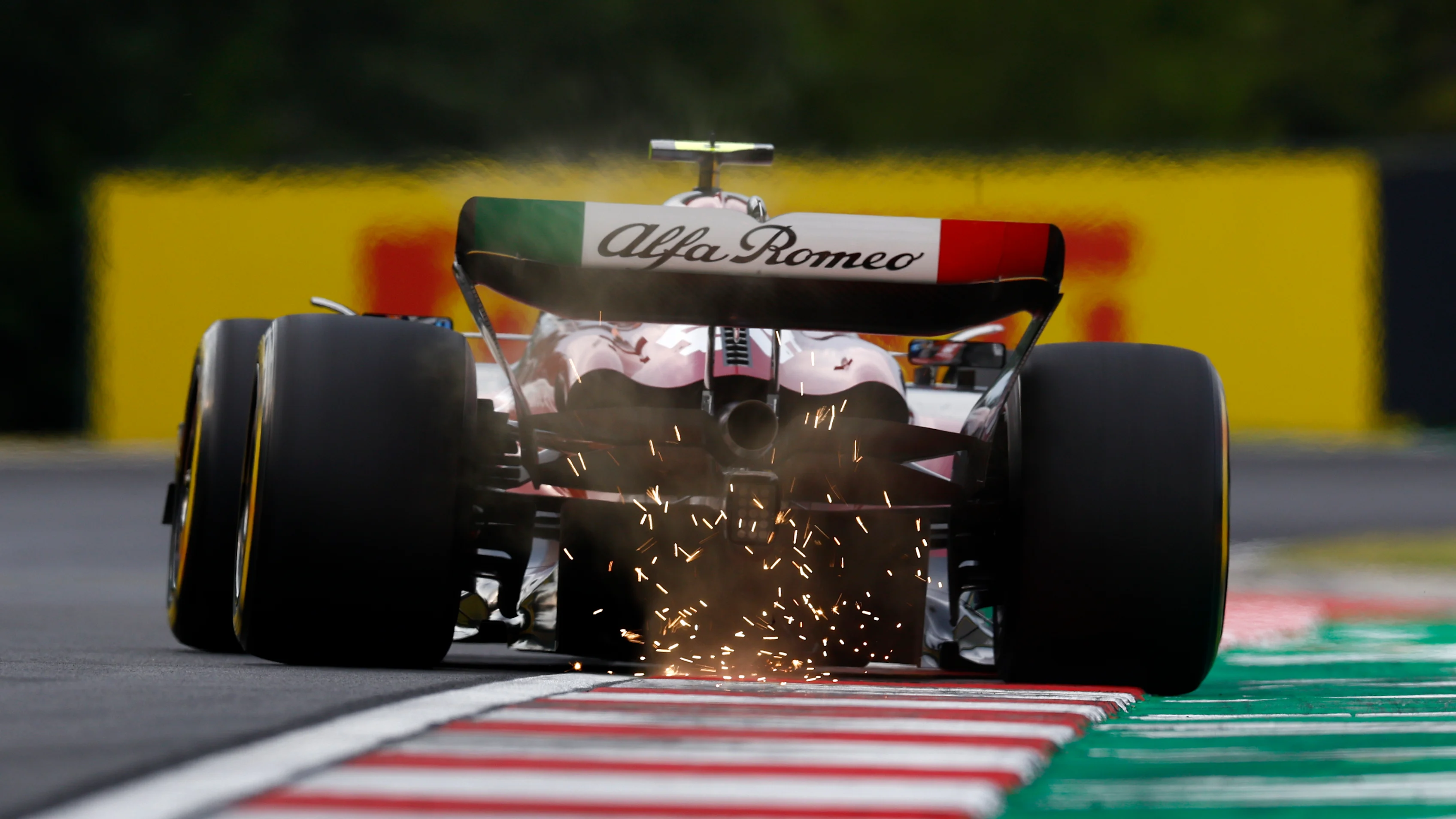 BUDAPEST, HUNGARY - JULY 22: Sparks fly behind Zhou Guanyu of China driving the (24) Alfa Romeo F1