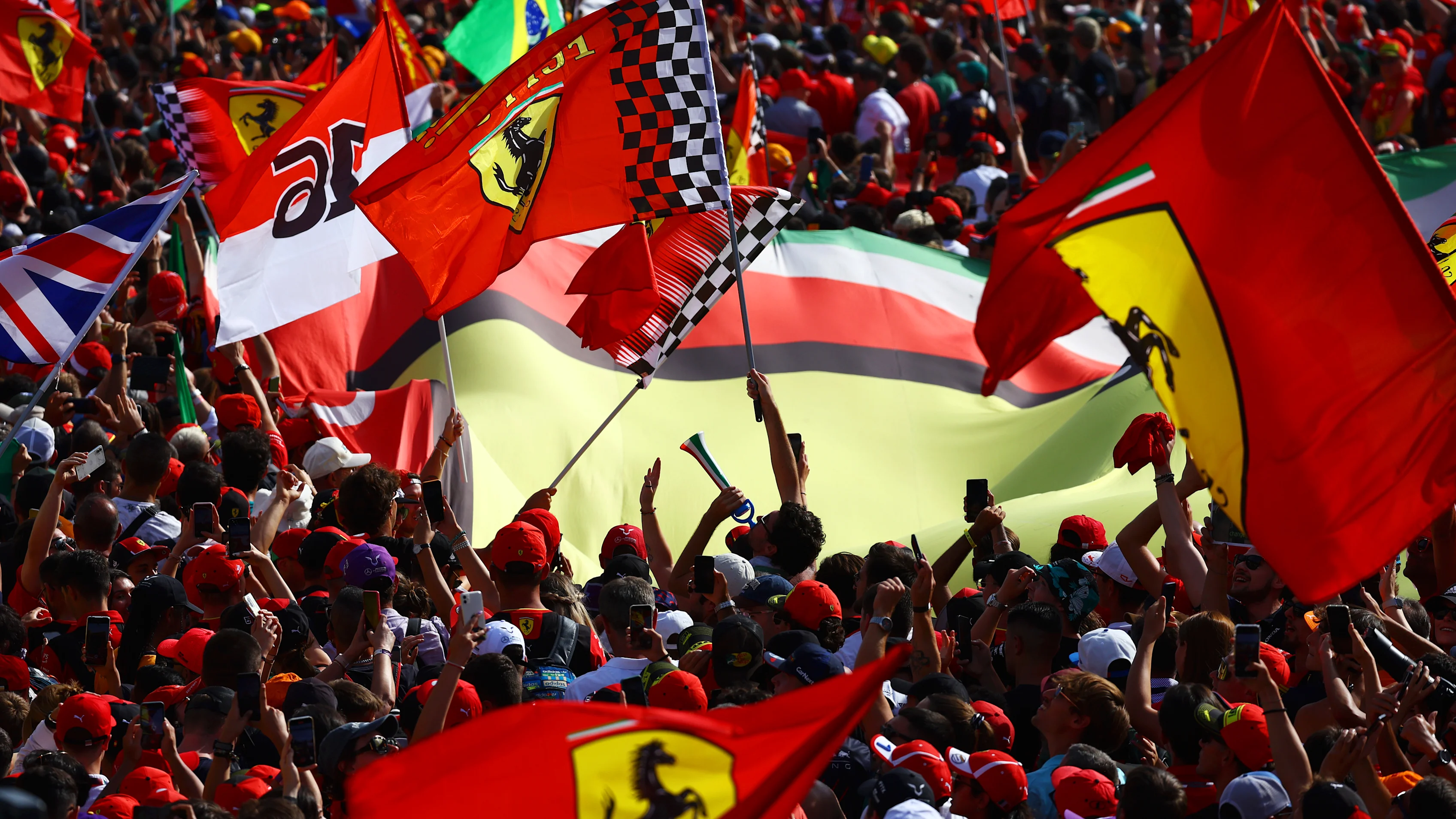 MONZA, ITALY - SEPTEMBER 03: Ferrari fans wave flags at the podium celebrations during the F1 Grand