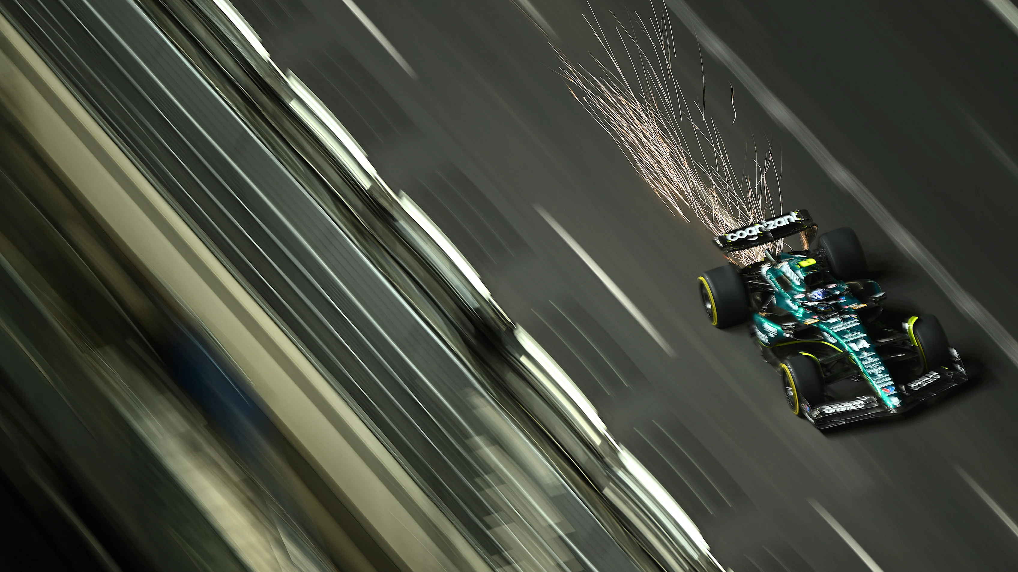 LAS VEGAS, NEVADA - NOVEMBER 17: Sparks fly behind Fernando Alonso of Spain driving the (14) Aston