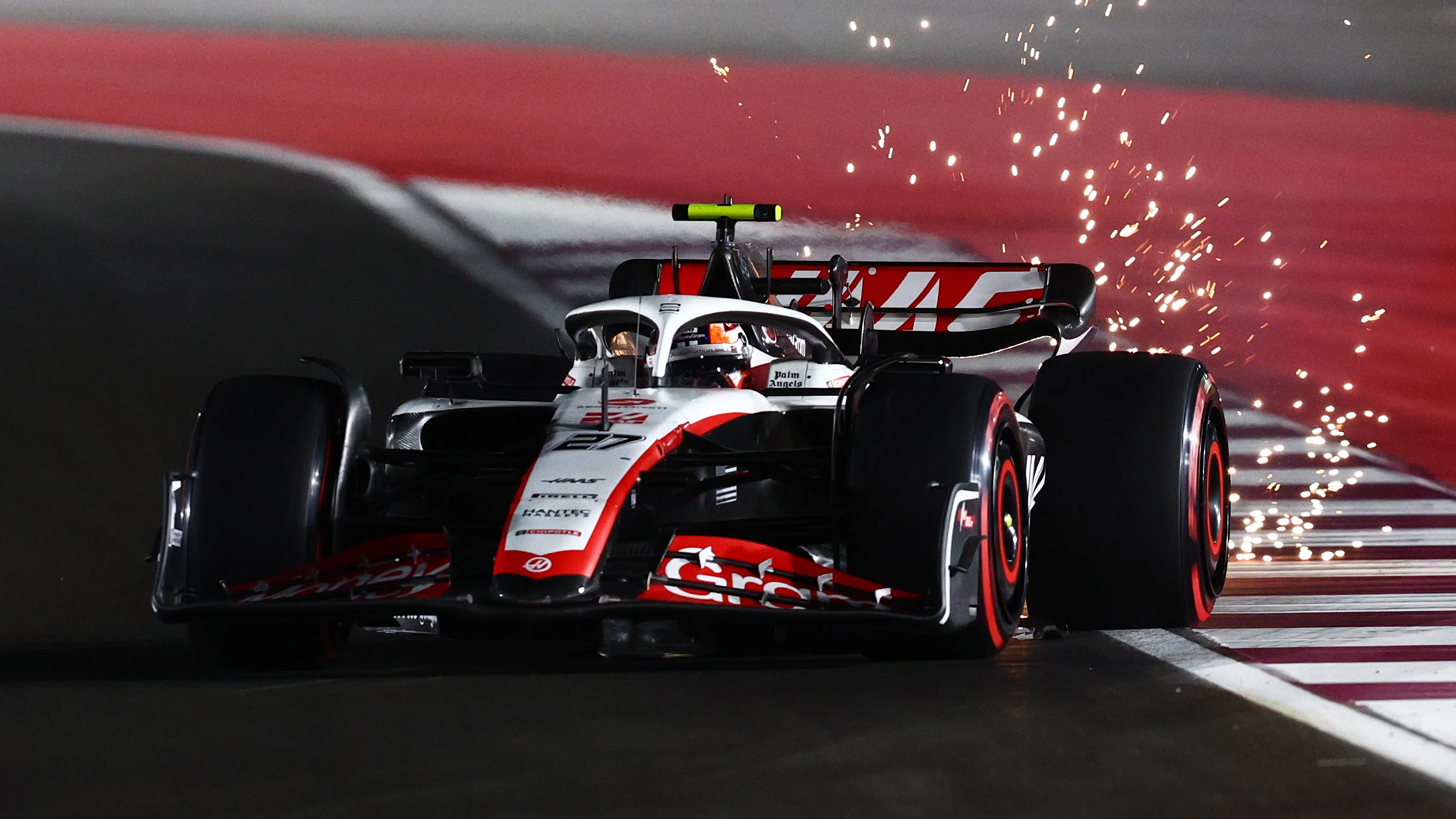 LUSAIL CITY, QATAR - OCTOBER 06: Sparks fly behind Nico Hulkenberg of Germany driving the (27) Haas
