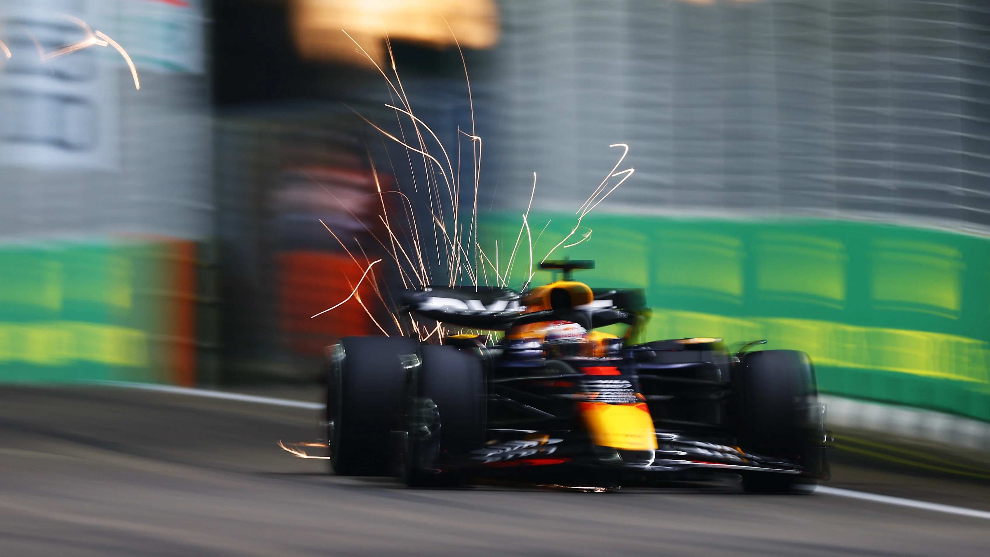 SINGAPORE, SINGAPORE - SEPTEMBER 20: Sparks fly behind Max Verstappen of the Netherlands driving