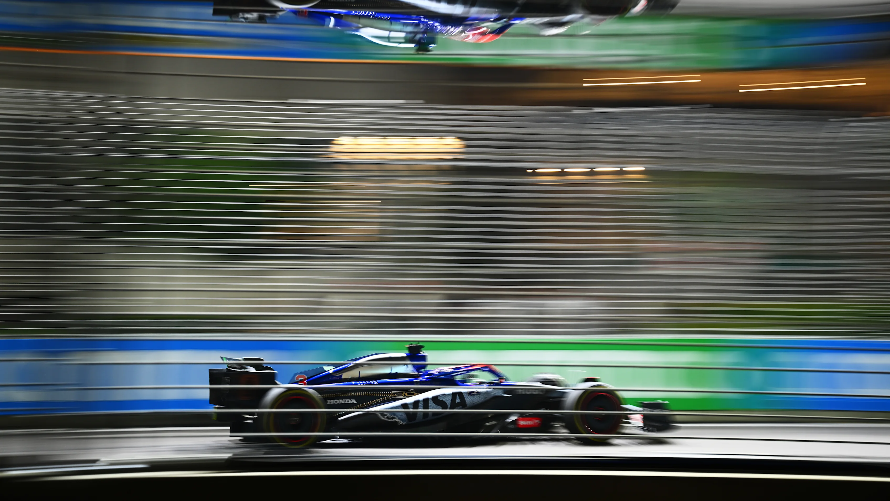 SINGAPORE, SINGAPORE - SEPTEMBER 20: Daniel Ricciardo of Australia driving the (3) Visa Cash App RB