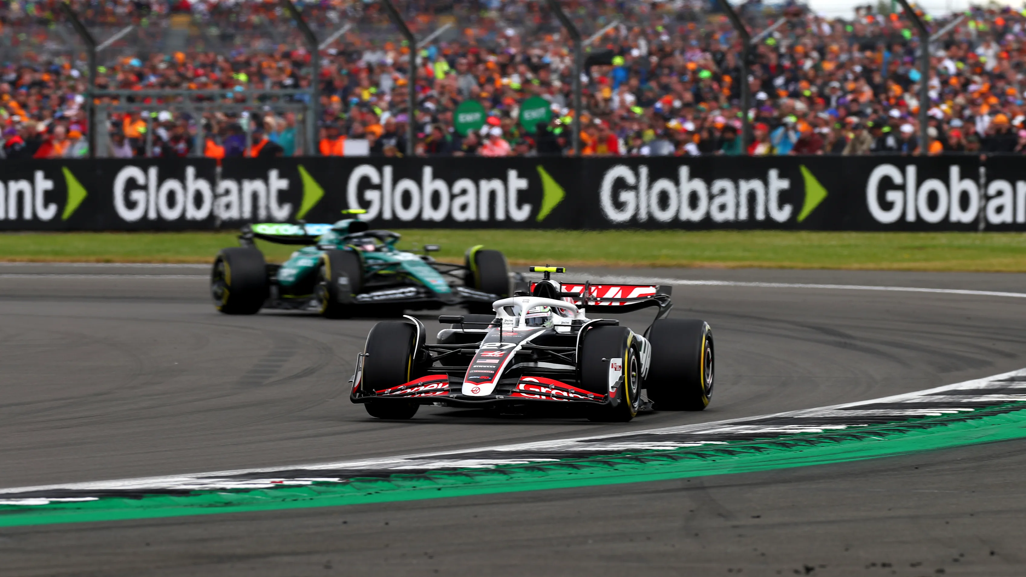 NORTHAMPTON, ENGLAND - JULY 07: Nico Hulkenberg of Germany driving the (27) Haas F1 VF-24 Ferrari leads Fernando Alonso of Spain driving the (14) Aston Martin AMR24 Mercedes during the F1 Grand Prix of Great Britain at Silverstone Circuit on July 07, 2024 in Northampton, England. (Photo by Peter Fox - Formula 1/Formula 1 via Getty Images)