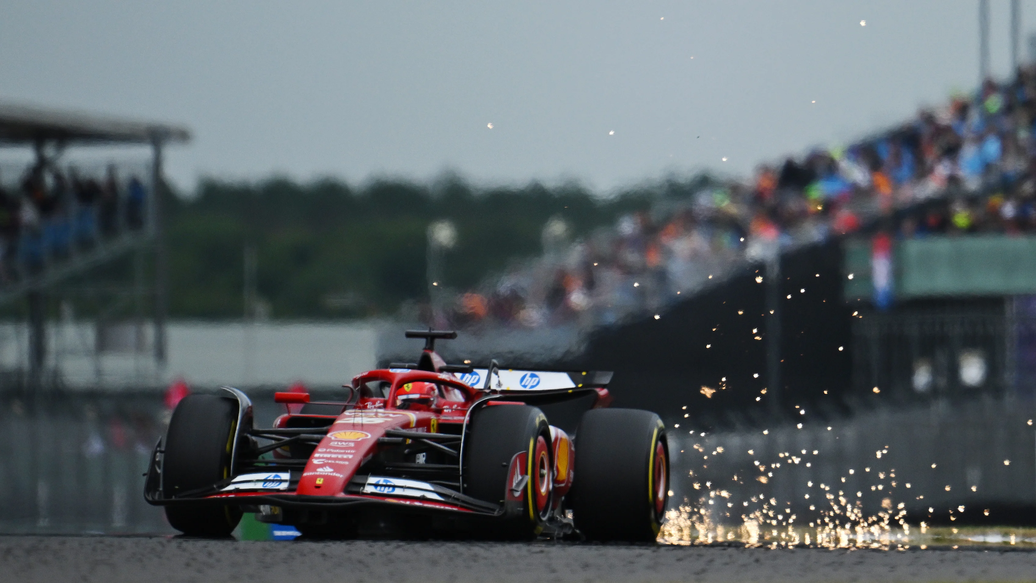NORTHAMPTON, ENGLAND - JULY 05: Sparks fly behind Charles Leclerc of Monaco driving the (16) Ferrari SF-24 on track during practice ahead of the F1 Grand Prix of Great Britain at Silverstone Circuit on July 05, 2024 in Northampton, England. (Photo by Mario Renzi - Formula 1/Formula 1 via Getty Images)