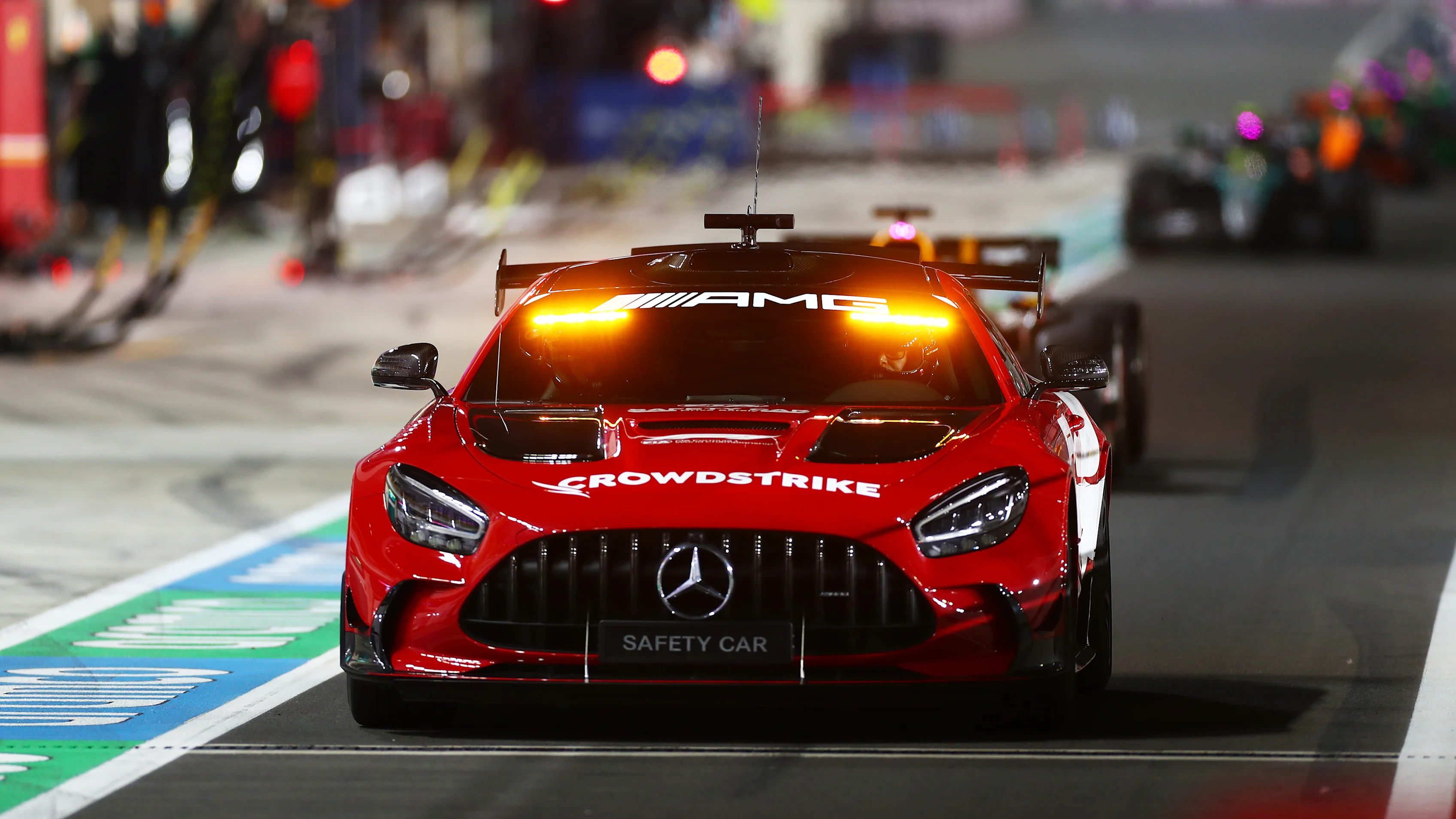 LUSAIL CITY, QATAR - DECEMBER 01: The FIA Safety Car leads the field down the Pit Lane during the