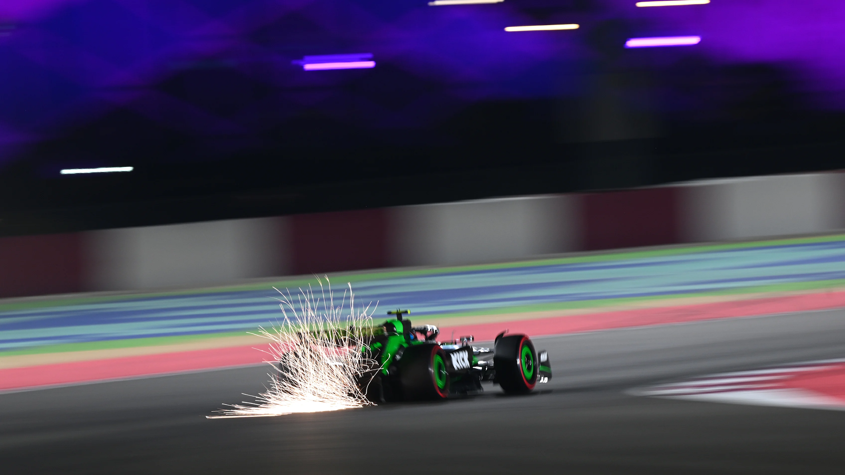 LUSAIL CITY, QATAR - NOVEMBER 30: Sparks fly behind Zhou Guanyu of China driving the (24) Kick Sauber C44 Ferrari during qualifying ahead of the F1 Grand Prix of Qatar at Lusail International Circuit on November 30, 2024 in Lusail City, Qatar. (Photo by Clive Mason/Getty Images)
