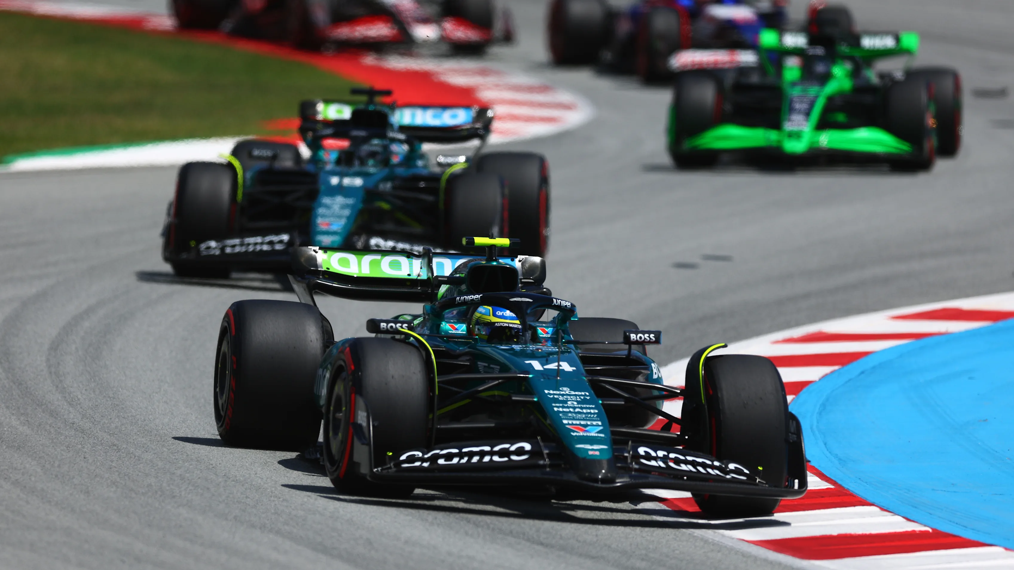 BARCELONA, SPAIN - JUNE 23: Fernando Alonso of Spain driving the (14) Aston Martin AMR24 Mercedes leads Lance Stroll of Canada driving the (18) Aston Martin AMR24 Mercedes during the F1 Grand Prix of Spain at Circuit de Barcelona-Catalunya on June 23, 2024 in Barcelona, Spain. (Photo by Clive Rose - Formula 1/Formula 1 via Getty Images)