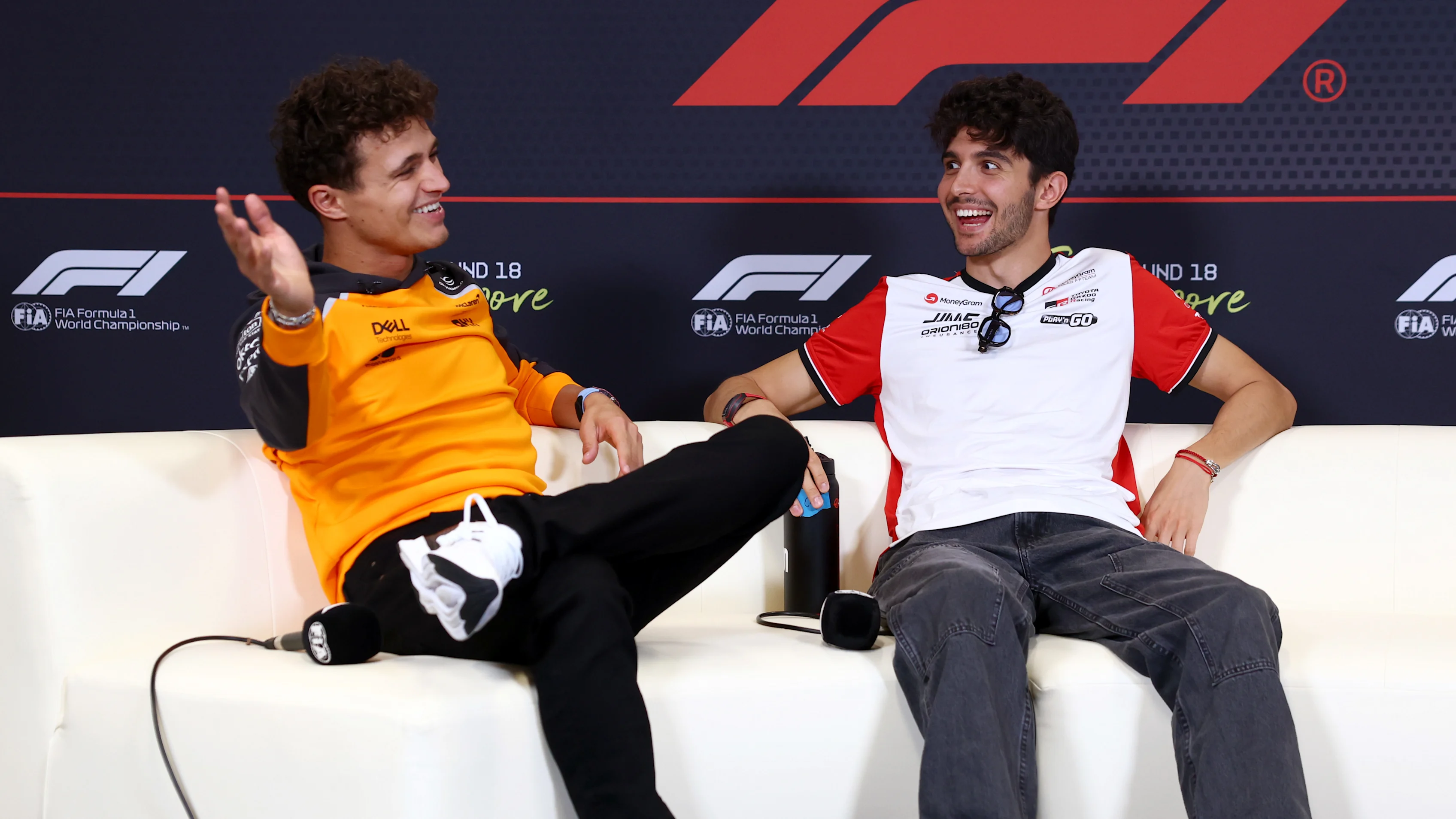 SINGAPORE, SINGAPORE - OCTOBER 02: Lando Norris of Great Britain and McLaren and Esteban Ocon of