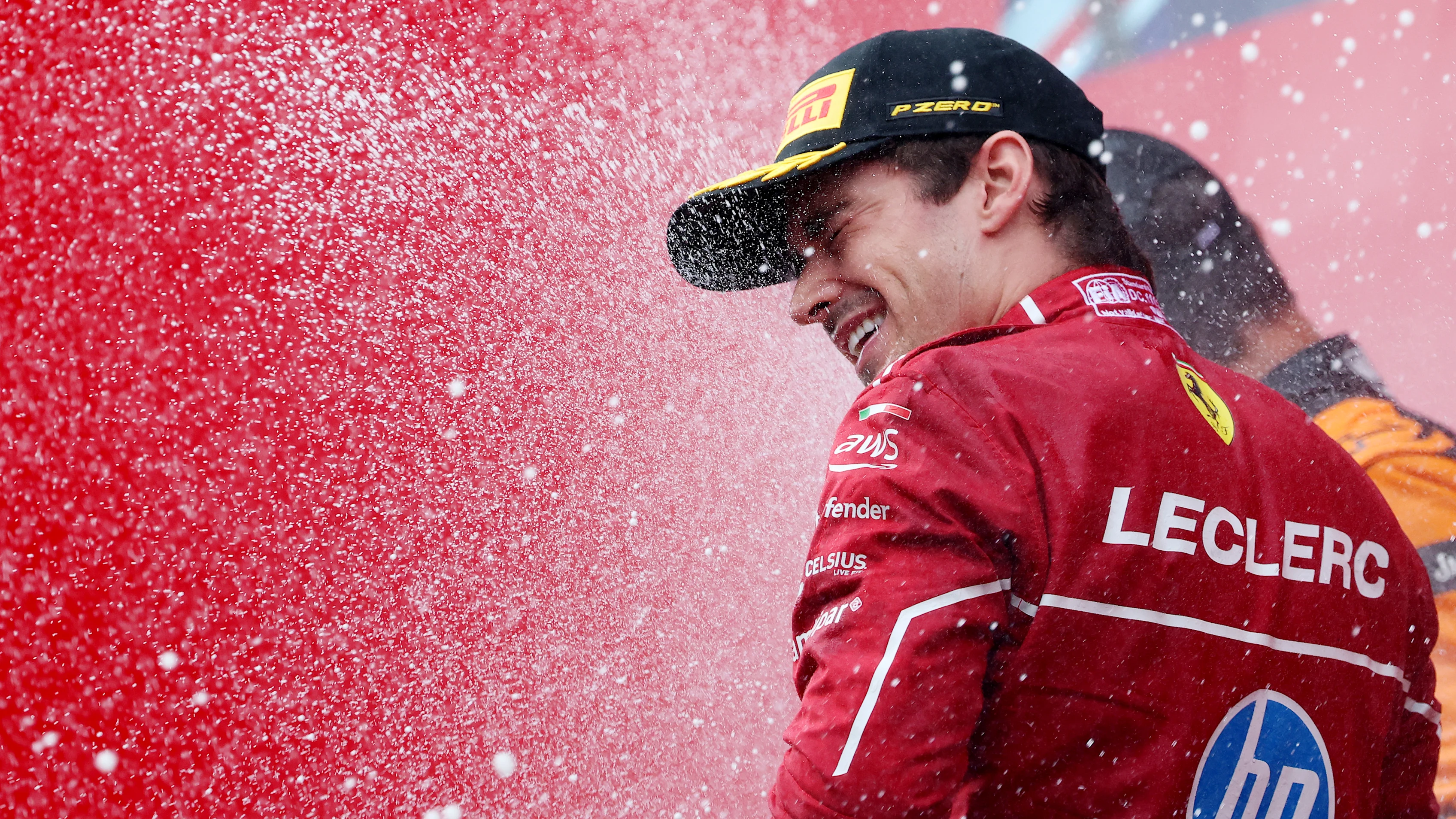SPA, BELGIUM - JULY 27: Third placed Charles Leclerc of Monaco and Scuderia Ferrari celebrates with Champagne on the podium during the F1 Grand Prix of Belgium at Circuit de Spa-Francorchamps on July 27, 2025 in Spa, Belgium. (Photo by Mark Thompson/Getty Images)