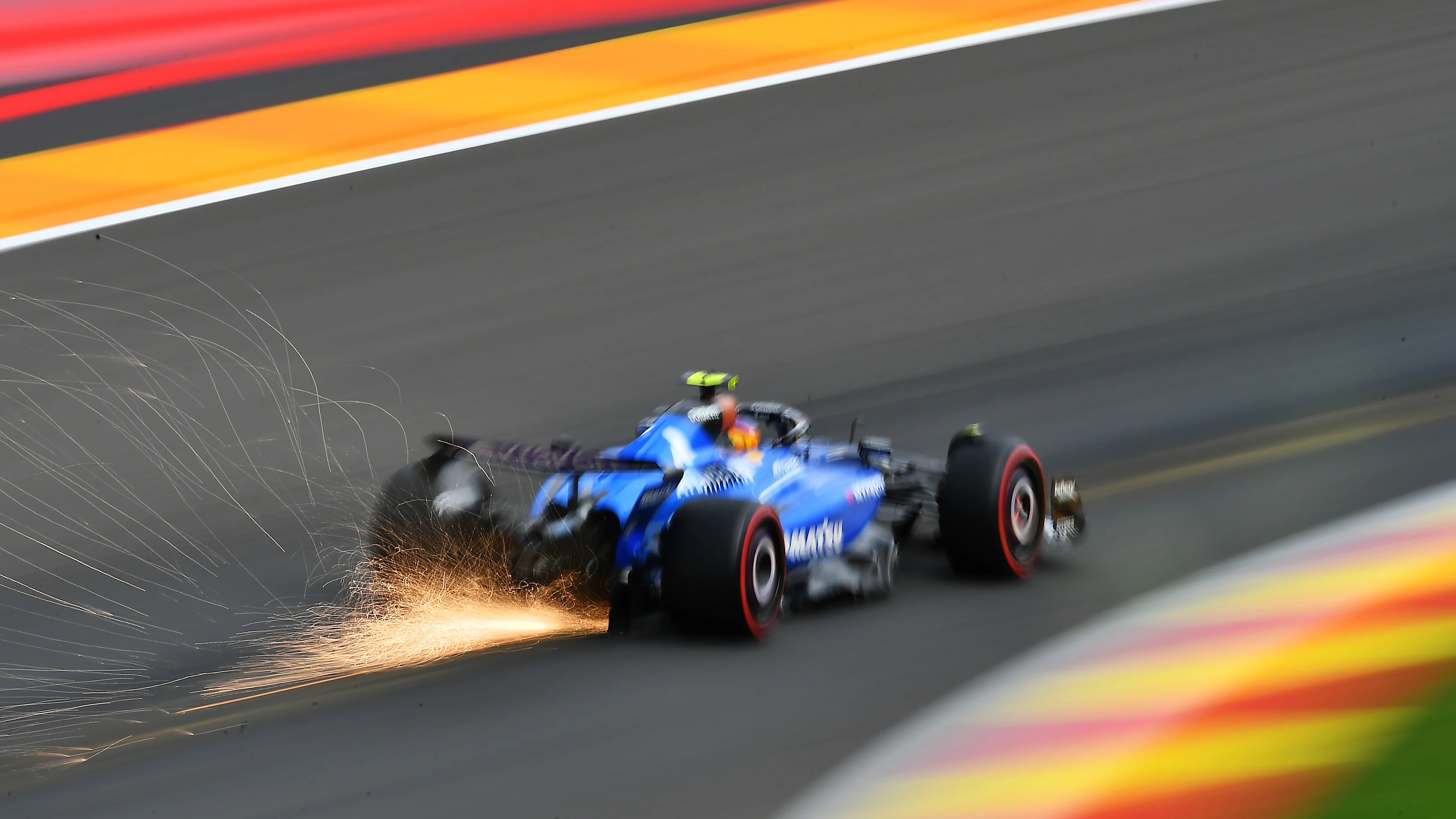 SPA, BELGIUM - JULY 26: Sparks fly behind Carlos Sainz of Spain driving the (55) Williams FW47 Mercedes on track during qualifying ahead of the F1 Grand Prix of Belgium at Circuit de Spa-Francorchamps on July 26, 2025 in Spa, Belgium. (Photo by James Sutton - Formula 1/Formula 1 via Getty Images)